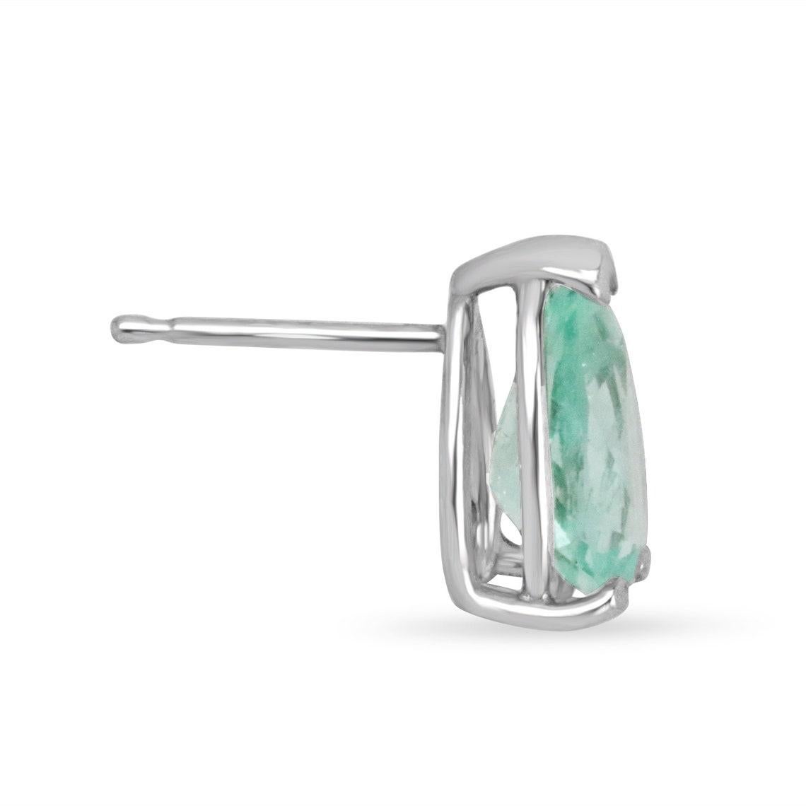 Two beautiful, natural pear-cut Colombian emeralds are set in a classic 3 prong setting. These pear-cut emeralds were sourced from Muzo and tested for 100% Genuine gemstones. A unique, light green color is seen in these beauties and excellent eye