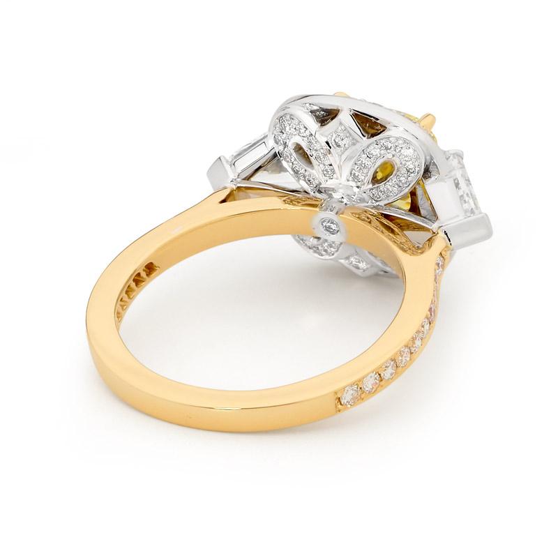 This beautifully crafted Matthew Ely two tone 18ct yellow and white gold ring features a stunning 2.51ct cushion cut Si2 Yellow Diamond.  (GIA 2151841381) with shoulder stones 2 = 0.90CT Shield cut FG VS/SI Diamonds + 32 = 0.465CT RBC FG VS