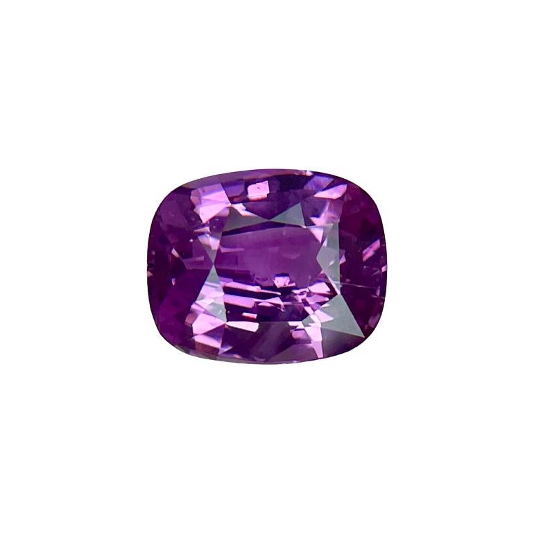 This is a vivid pink cushion sapphire mounted in a platinum ring with 0.37Ct of brilliant white cadillac diamonds. Suitable for any occasion!