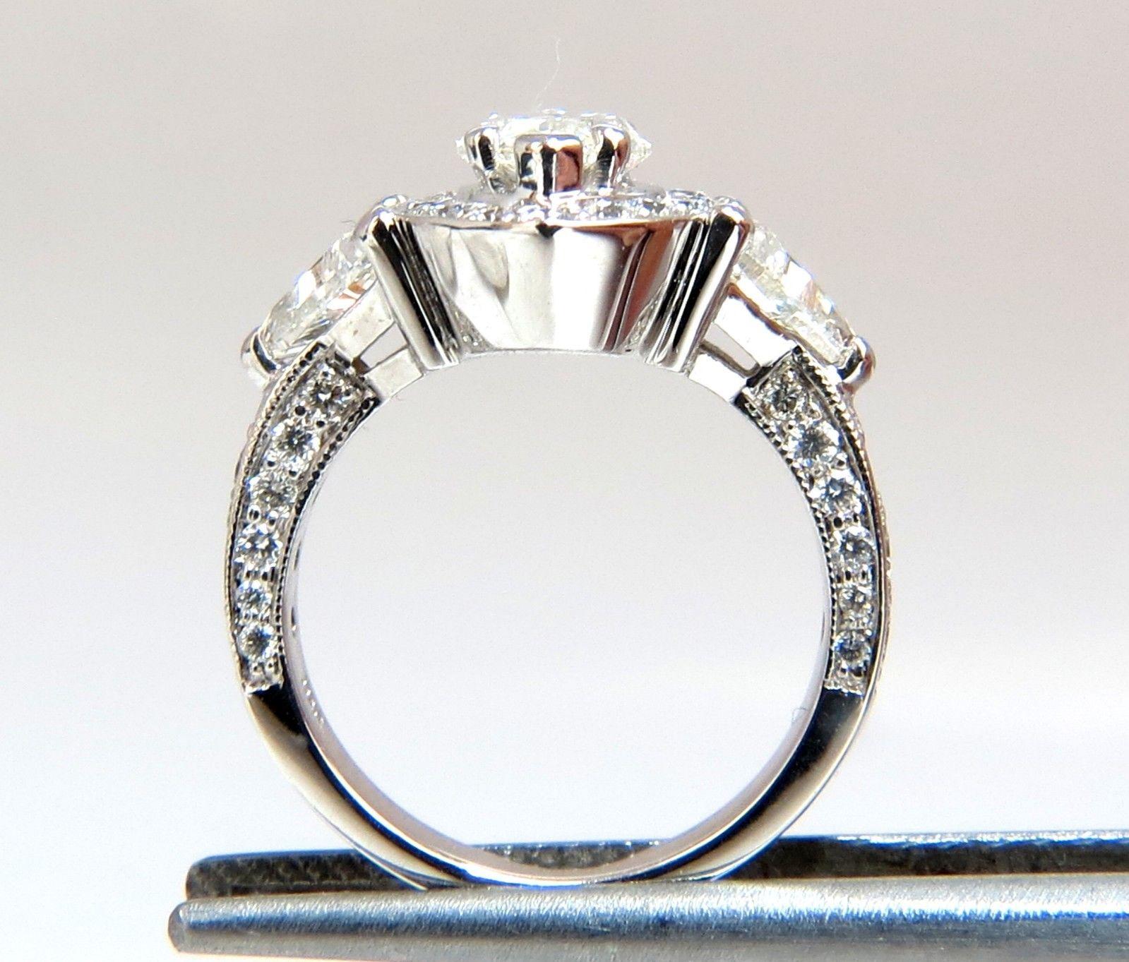 Marquise Mod Halo

1.01ct. Marquise diamond Ring

I-color, Si-1 clarity

9 x 5.5mm

.70ct (2) Side Trilliant cut diamonds

I-color vs-2 clarity

& .80 round diamonds accents:

H-color Vs-2 clarity

14kt. white gold. 

5.1 grams.

Ring is 14.5mm