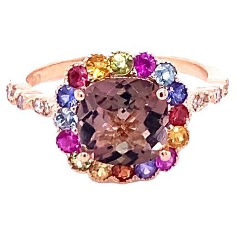 2.51 Carat Tourmaline Sapphire Diamond 14 Karat Rose Gold Cocktail Ring
Affordable! Luxury! Fine jewelry! Fashion!

This Ring has a Cushion Checkered Cut Tourmaline that weighs 1.71 Carats and 16 Multi Sapphires that weigh 0.67 Carats. There are