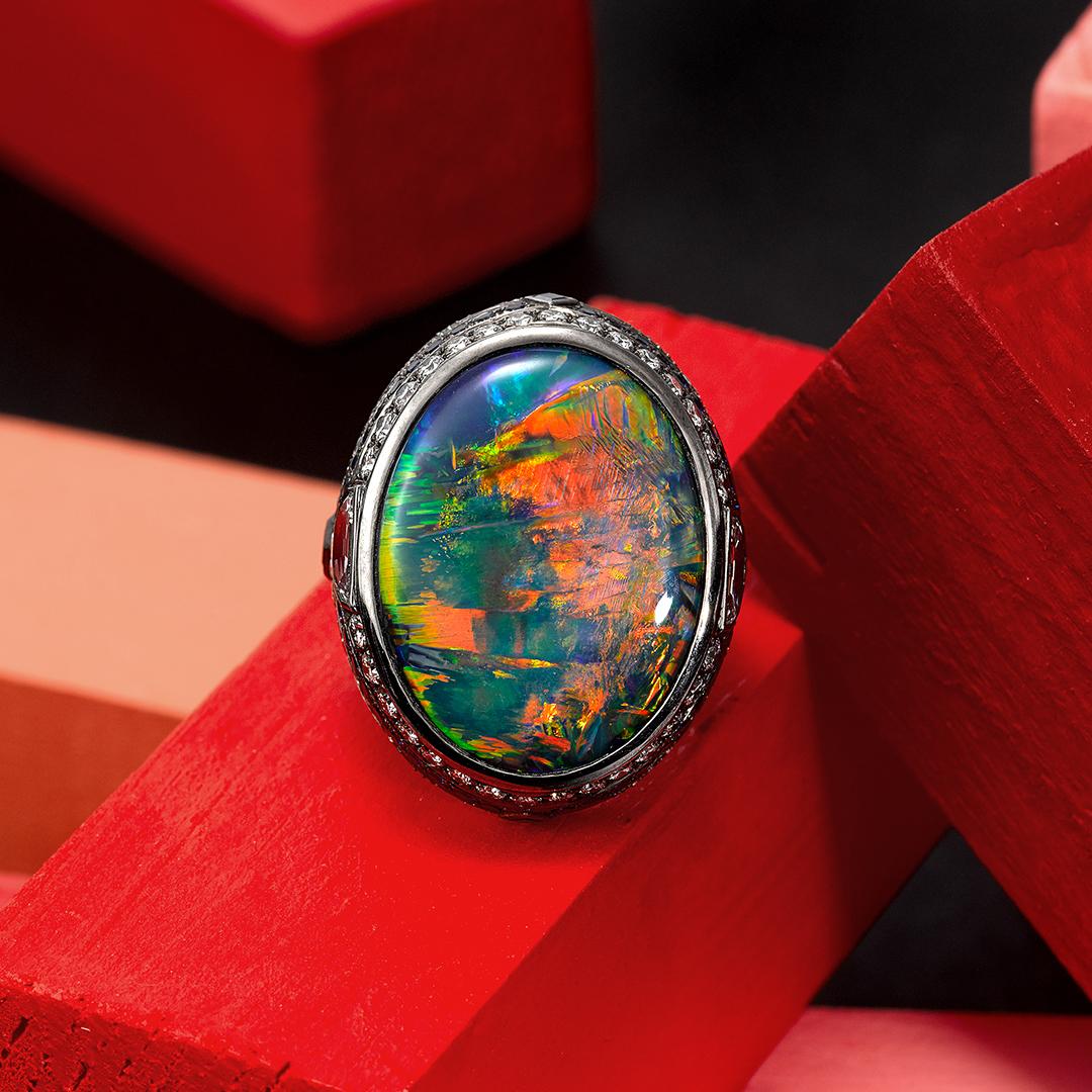 This one of a kind Ring features a very special 25.10ct lighting ridge Black Opal of exceptional quality (GSL certified), 142 white Diamonds weighing 3.24ct (color D / F clarity VS2) and 48 blue Sapphires weighing 0.97ct all set into 18ct white gold
