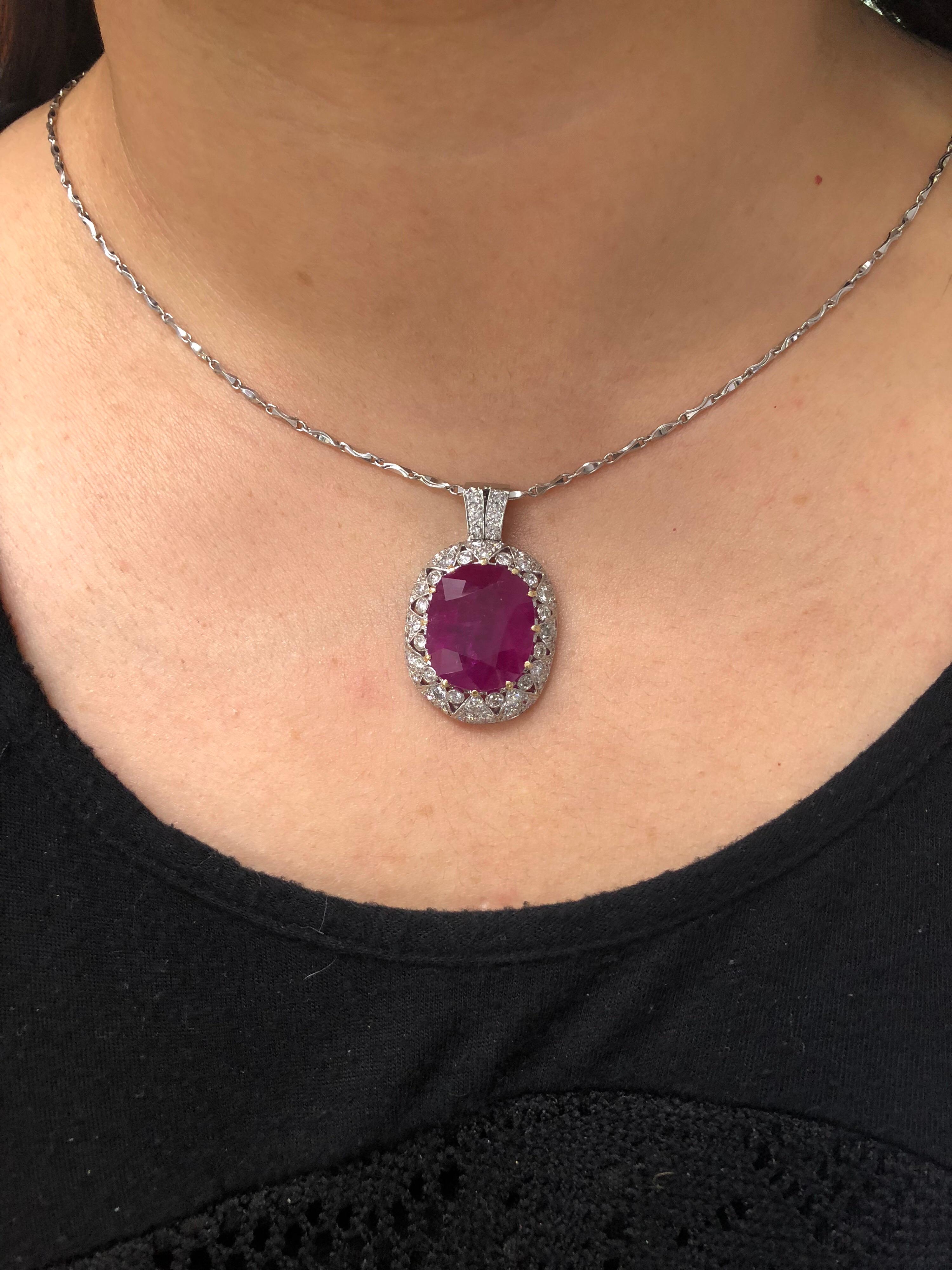 Platinum pendent set with 25.16 carat oval Burmese Ruby and 2.00 carats total weights of round brilliant diamonds. Necklace comes with AGL gemstone report. The classic design makes this pendant necklace so charming and wearable.
