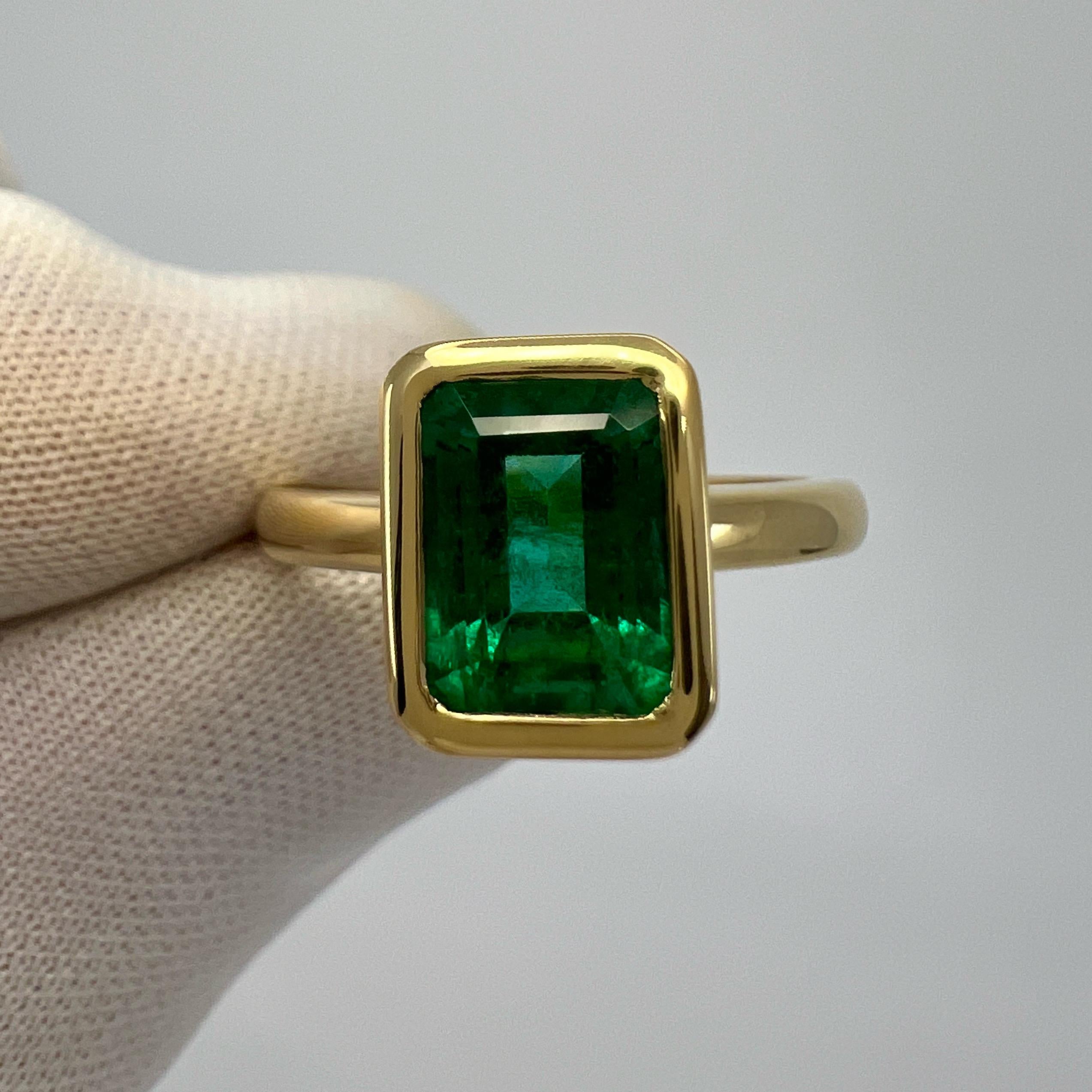 Fine Deep Green Octagon Cut Natural Emerald 18k Yellow Solitaire Bezel Rubover Ring.

2.51 Carat emerald with a stunning deep green colour and very good clarity. Some small natural inclusions and colour zoning visible when looking closely at some