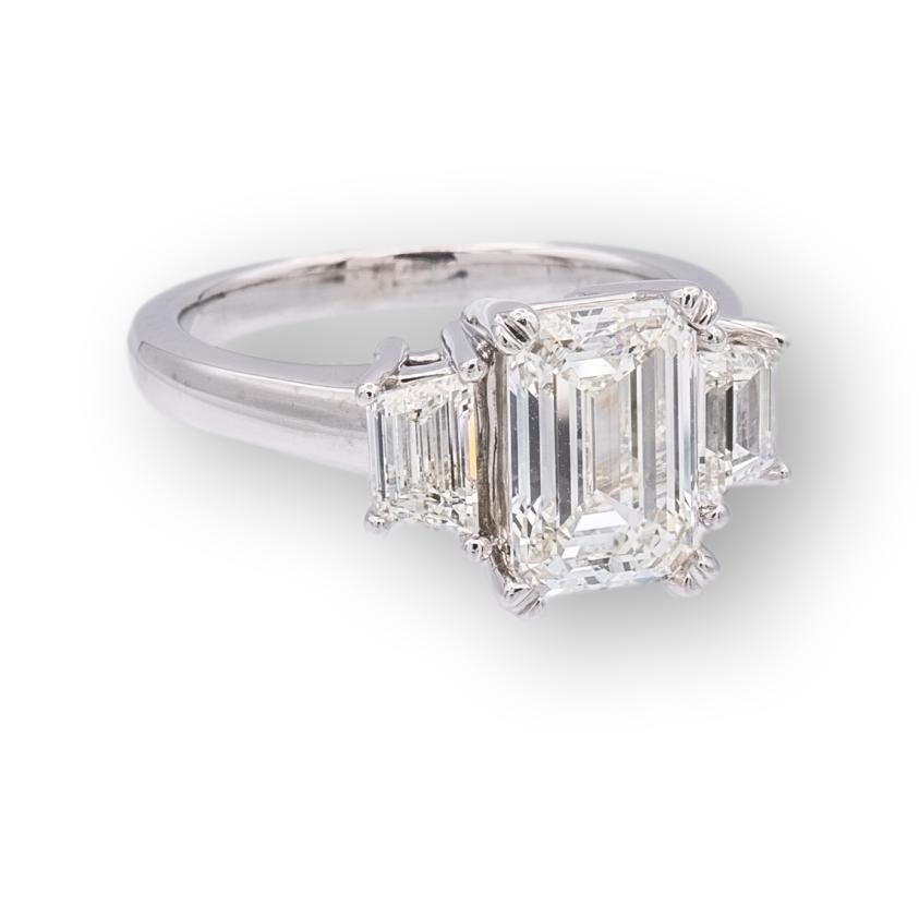 Three Stone diamond engagement ring featuring an Emerald Cut diamond center weighing 2.51 carats I color and VS1 clarity certified by the GIA (Gemological Institute of America) flanked by 2 trapezoid diamonds weighing 0.81 carats total weight I