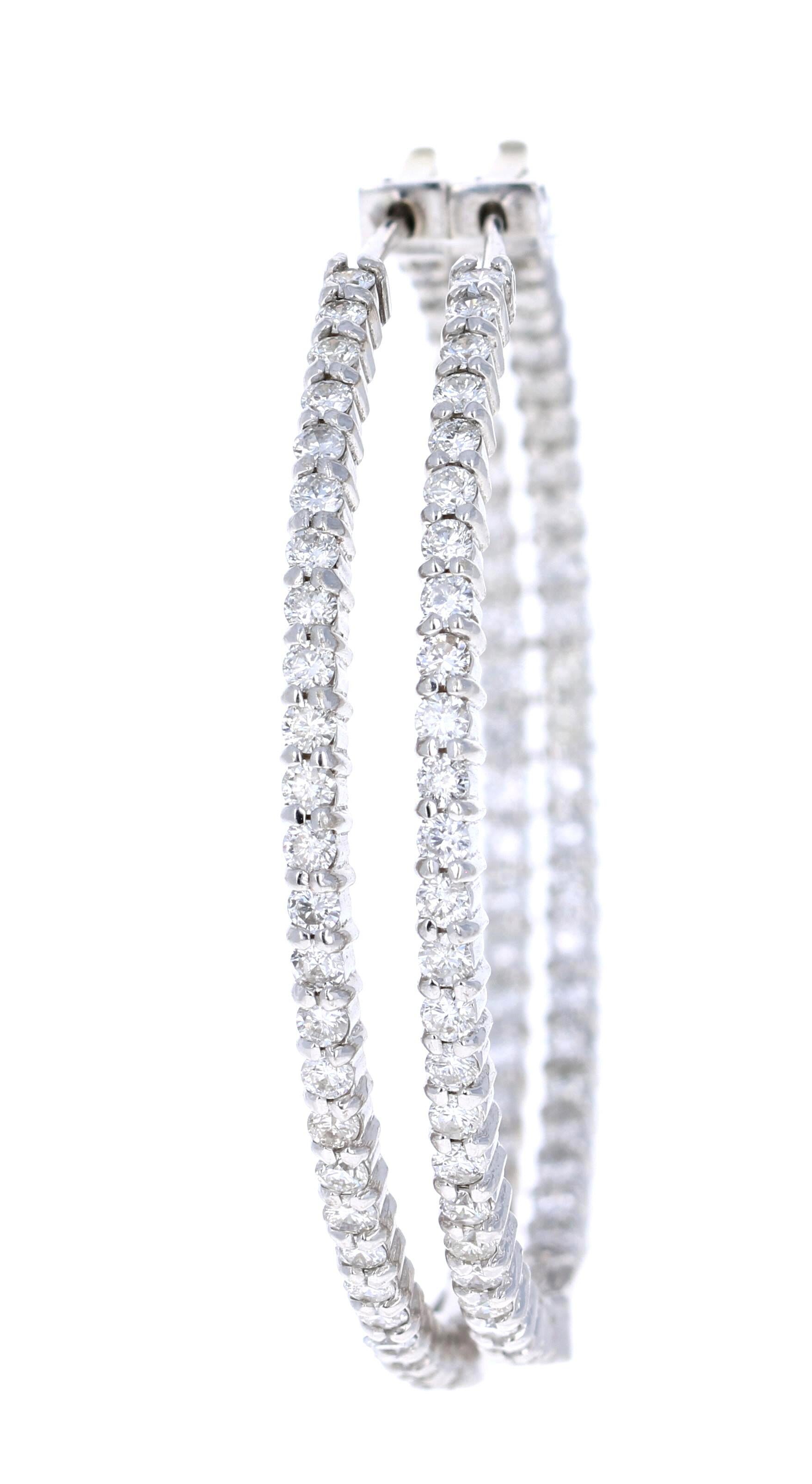 These beautiful and simple hoop earrings are 102 Round Cut Diamonds that weigh 2.52 Carats. 

The hoops are set in 14 Karat White Gold and weigh approximately 13.3 grams. 

