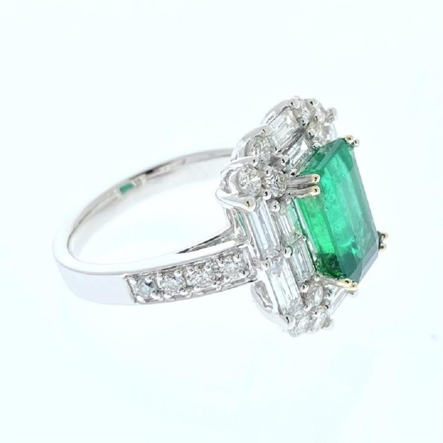 This ring is a dazzling embodiment of elegance and sophistication. Crafted in 18 karat white gold, it features a striking 2.52 carat emerald-shaped green emerald as its centerpiece. The emerald's rich green hue is truly captivating, evoking a sense