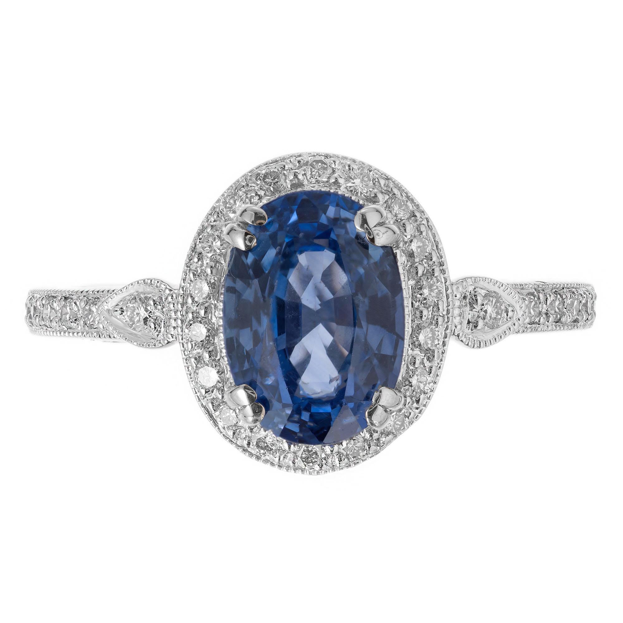 Sapphire and diamond engagement ring. Oval center sapphire with a halo of round diamonds. 18k white gold setting with micro pave set round accent diamonds along the shank. GIA certified # 5212550272

1 oval Ceylon Sapphire 2.47ct  8.81 by 6.20 by