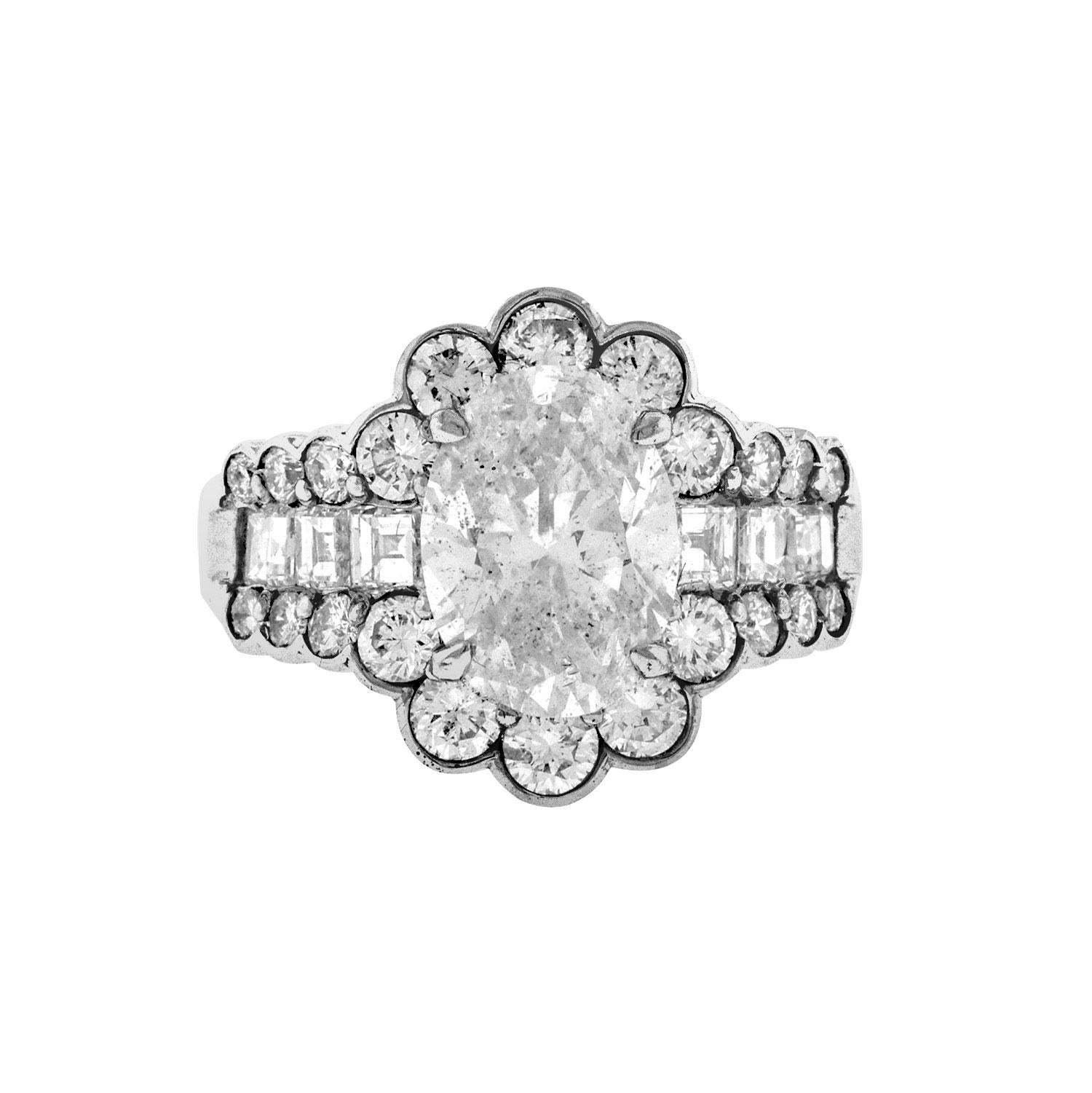 A gorgeous design, this platinum made ring features a 2.52 carat oval-shaped diamond. It is accented by 2.47 carats of round brilliant and square-baguette diamonds set around the oval diamond. Hand-fabricated in platinum and ready to be worn. The