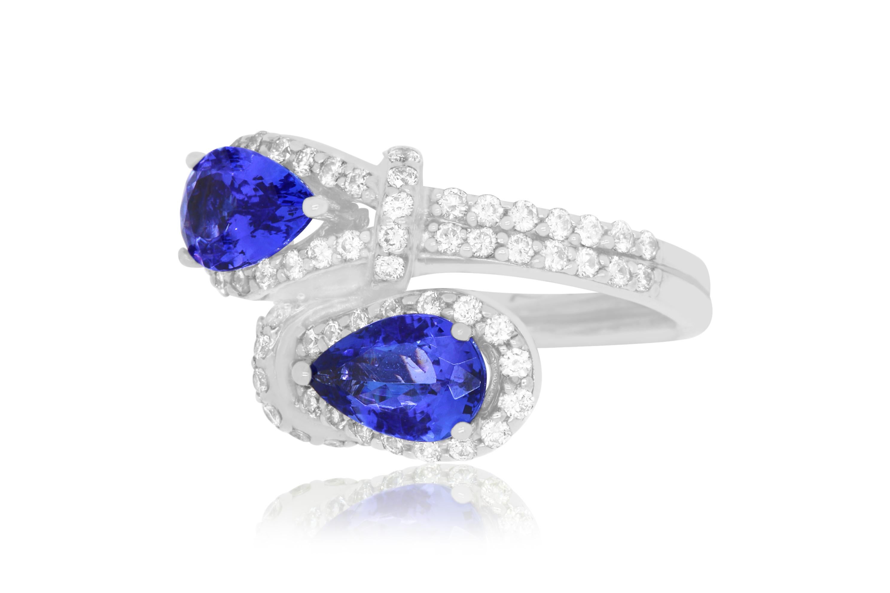 This unique piece features 2 stunning Pear Shaped Tanzanites totaling at 2.52 Carats. Set in 14K white gold and surrounded by brilliant round white diamonds totaling 1 Carat, this ring will wrap your finger in luxury!

Material: 14k White