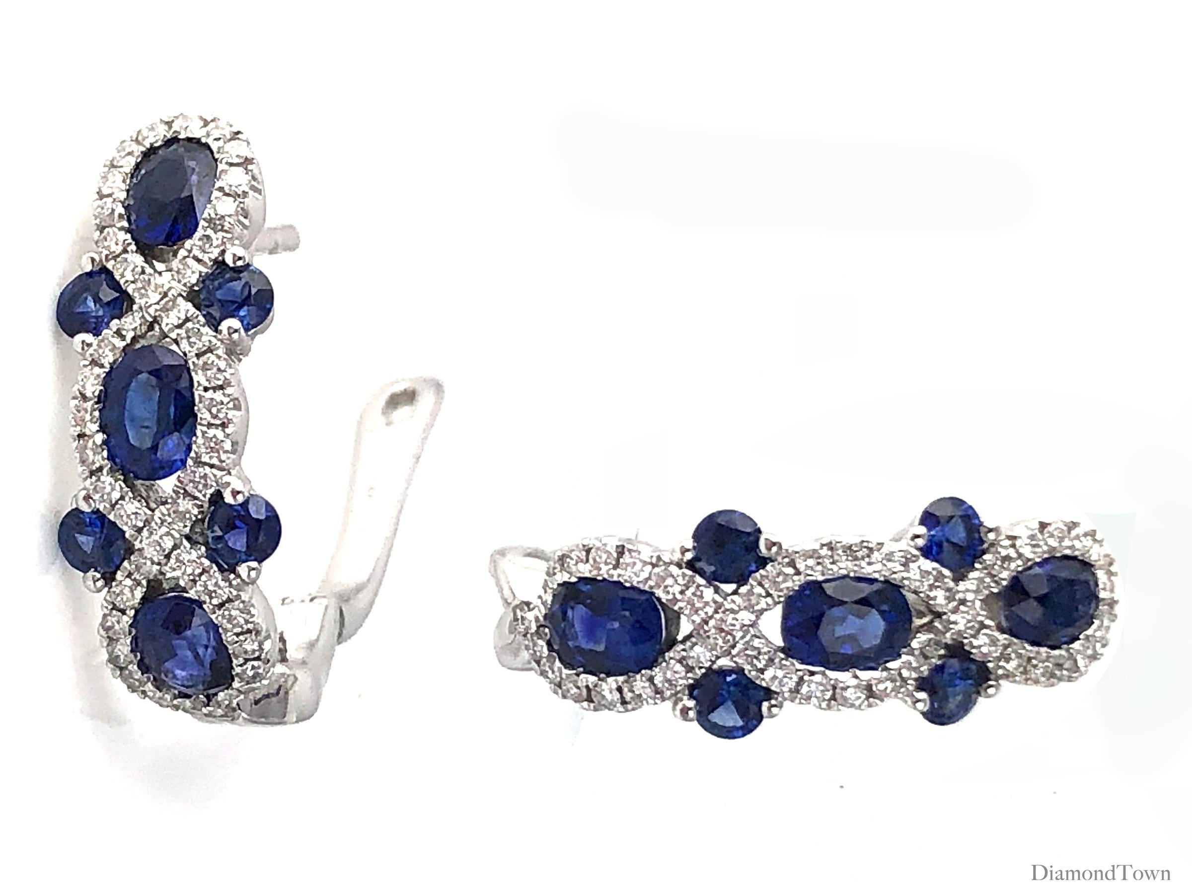 (DiamondTown) These stunning earrings feature round and oval cut vivid blue sapphires (total carat weight 2.52 carats) in an interlaced design of round white diamonds (total diamond weight 0.48 carats).

Set in 18k White Gold.
Lever-back