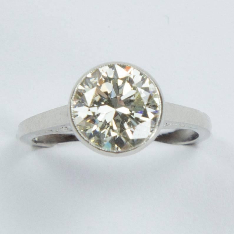 Beautiful Art Deco Engagement Ring boasts a 2.52 Carat round brilliant cut Diamond securely nestled in a beautiful Hand crafted Platinum Custom made mounting; diamond measures approx. 9mm x 9mm x 5.1mm; clarity VS1. Color L.Ring size 6.5;