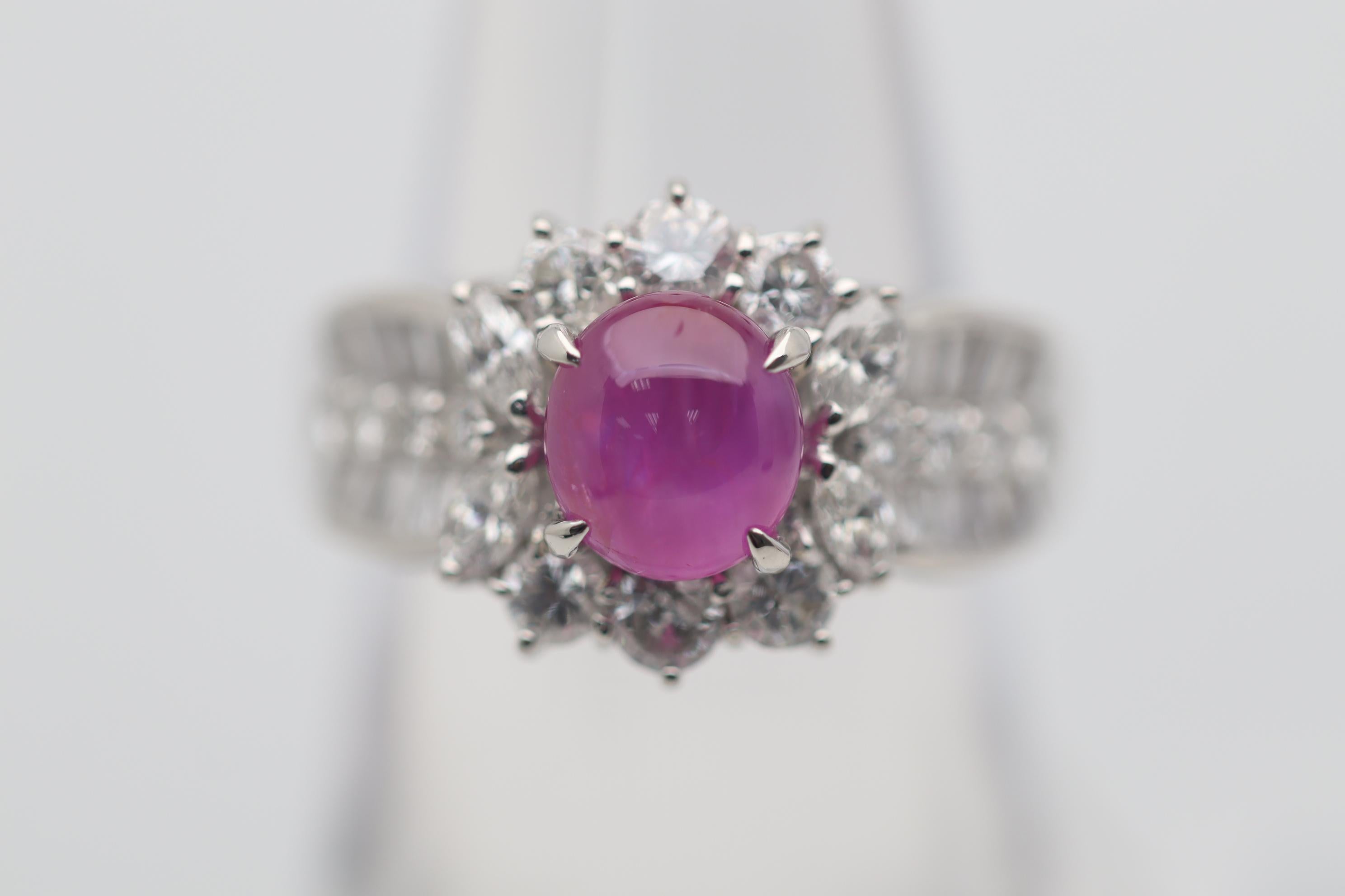 A fine and stylish ring featuring a 2.52 carat gem star ruby. It has a rich and bright red color with excellent luster and a strong 6-rayed star. It is complemented by 1.46 carats of round brilliant, marquise, and baguette-cut diamonds set around