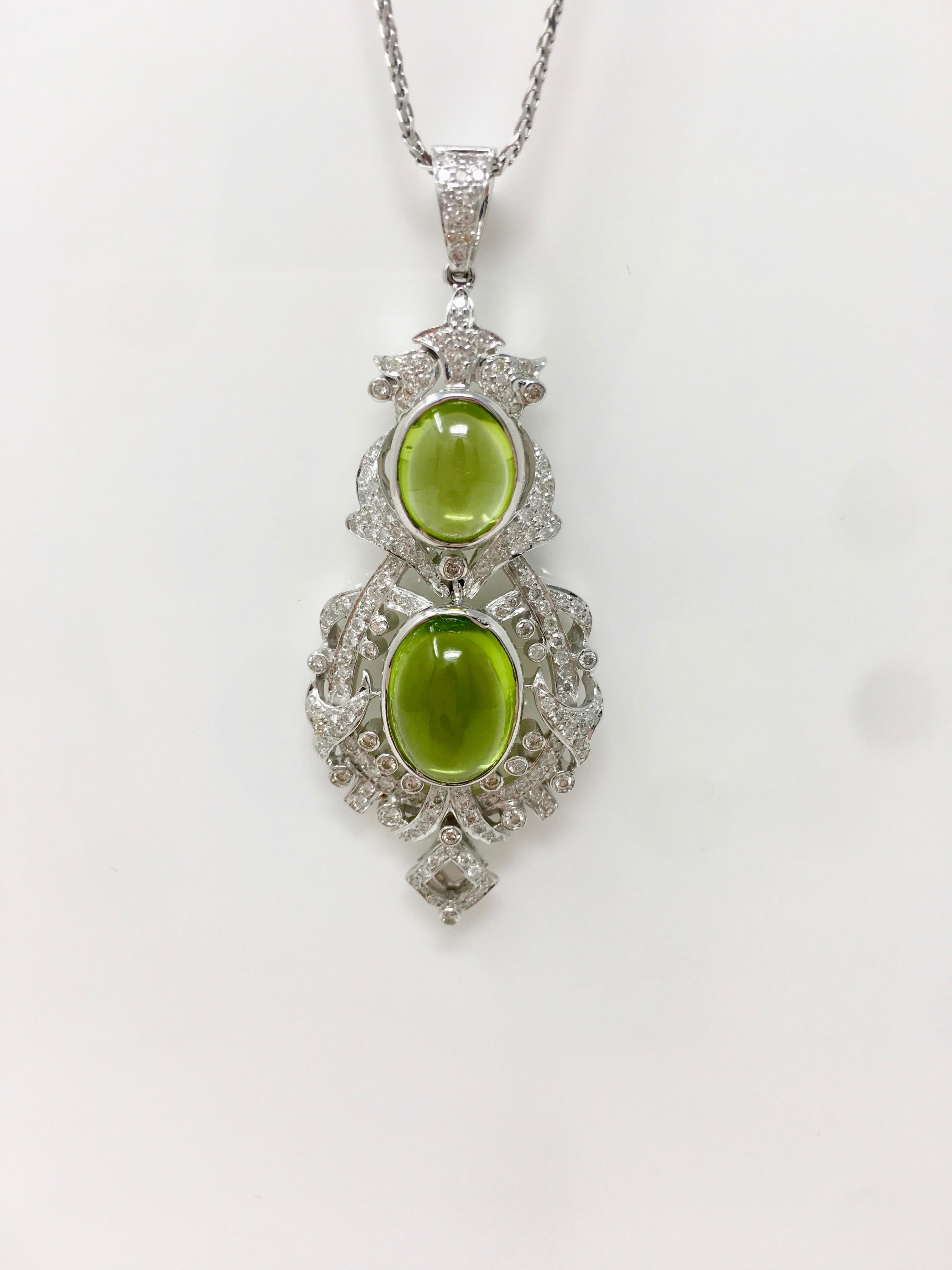 This beautiful custom handmade creation by Moguldiam Inc features a pair of earrings and a pendant. The diamond weight is 2.52 carat with VS clarity and GH color and peridot weight is 17.34 carat. The gold weighs 31.900 grams. The measurements on