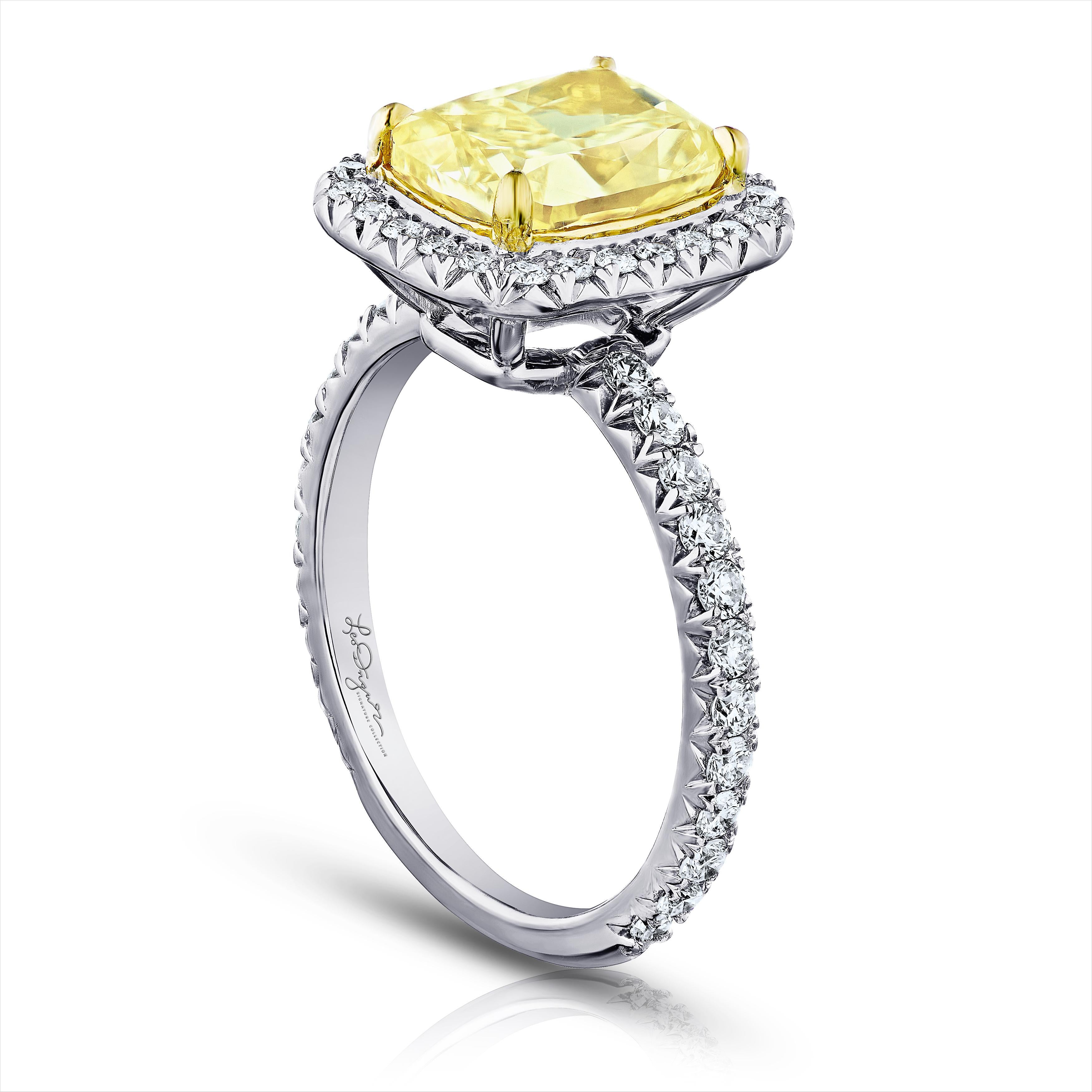 Stunning Yellow Cushion Cut 2.52ct GIA Certified Y-Z color SI2 set in a 18kt yellow cup to give this beauty the boost it needs to compete with those Fancy intense yellows but a a much nicer price! This classic halo contains .60 ct. total weight of