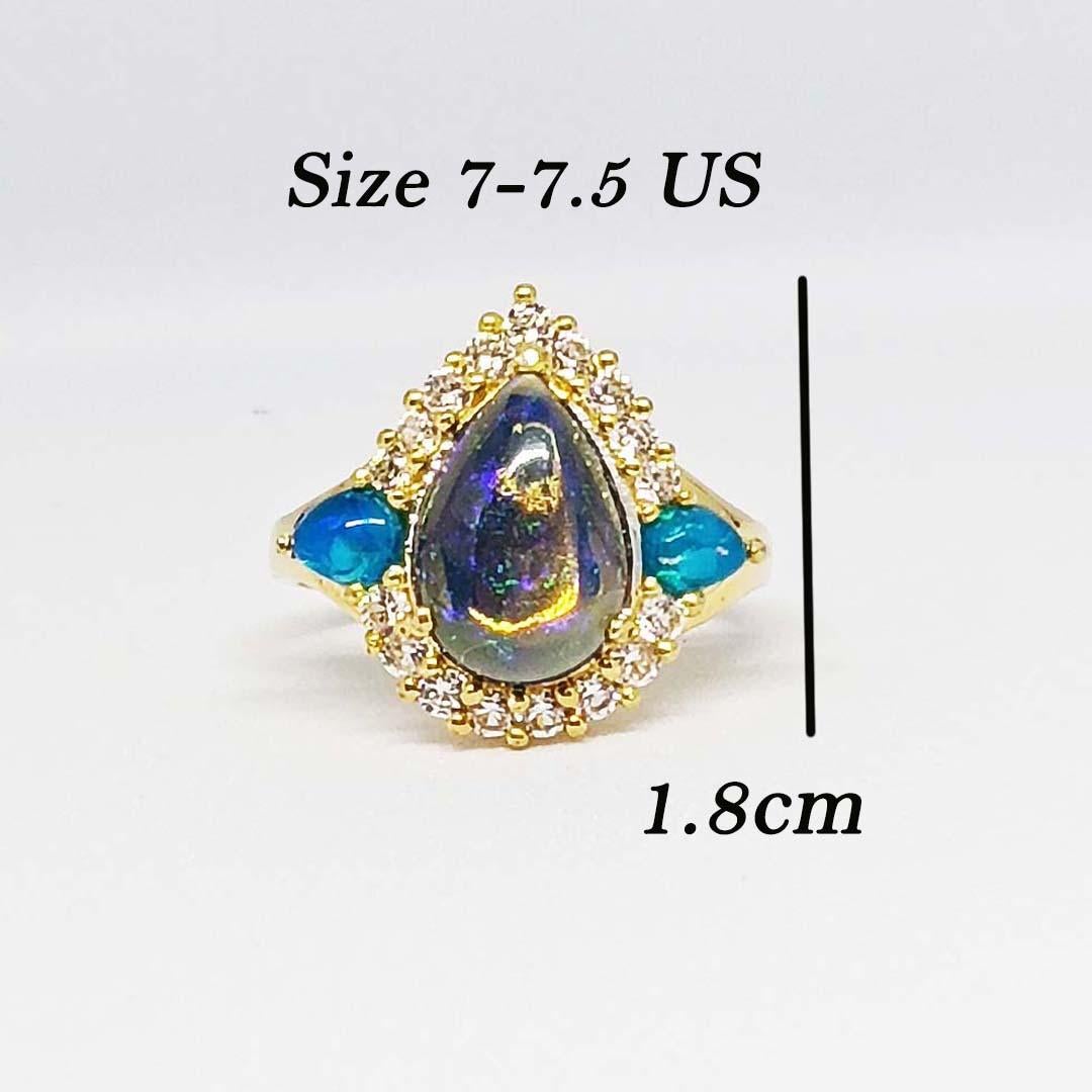 Black opal Pear 12x8.4 mm. 2.52 cts
Blue opal Pear 5x4 mm. 0.20 cts
White Zircon round 2 mm. 17 pcs.
Sterling Silver on 18K Gold Plated

Size ring 7.5 us