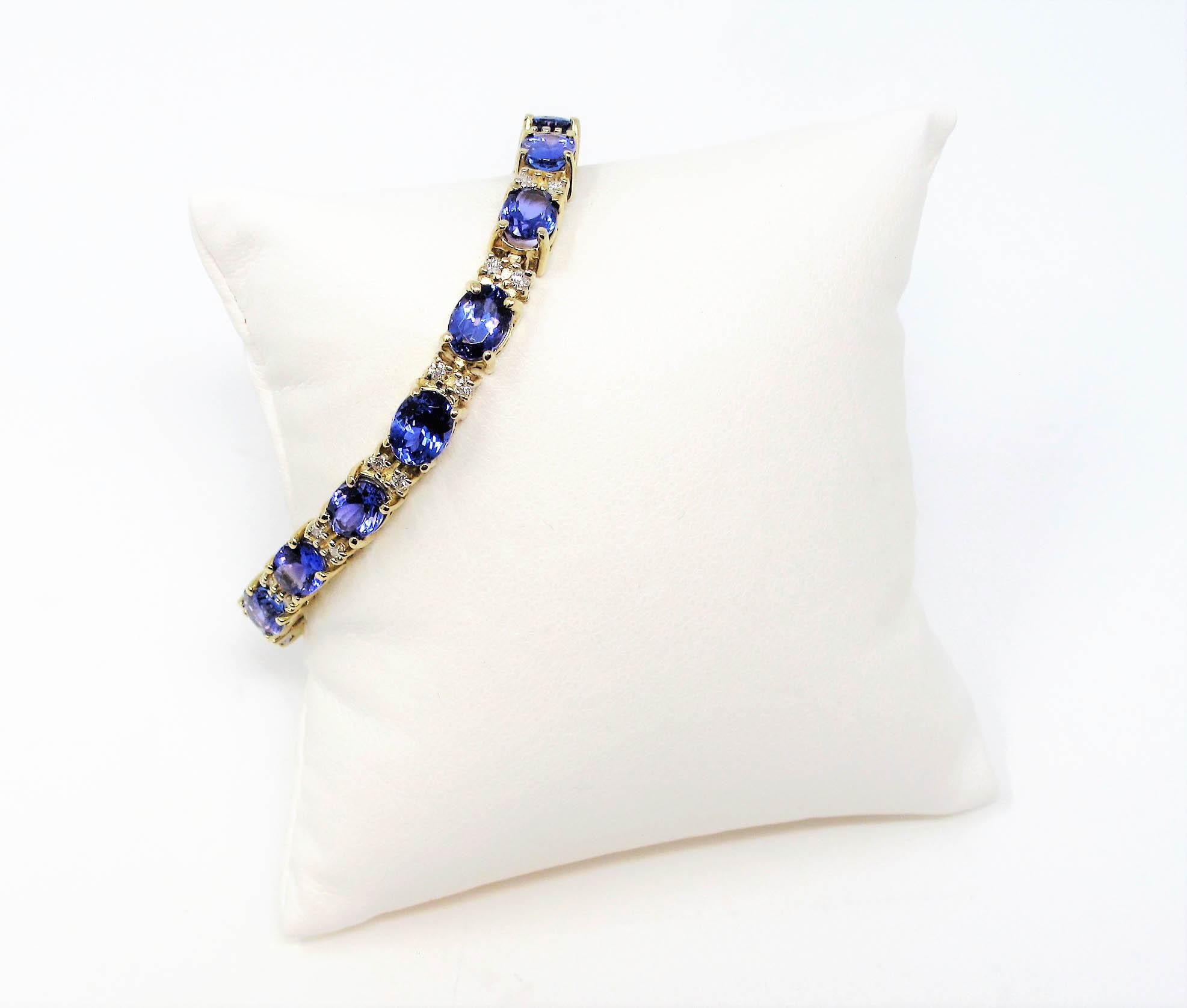 Adorn your wrist in this absolutely exquisite tanzanite and diamond tennis bracelet. The incredible vibrant tanzanite stones offer a stunning richness while the icy white diamonds dazzle throughout the piece. The sleek, straight line design sits