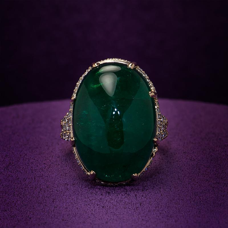 25.25cts Cabochon Oval Emerald Ring
Deep green emerald cabochon 25.25cts in a three row split ring with diamond pavé and a diamond halo. A beautiful centerpiece made by hand at Kaufmann de Suisse's atelier.

25.25cts AAA oval cabochon emerald
148