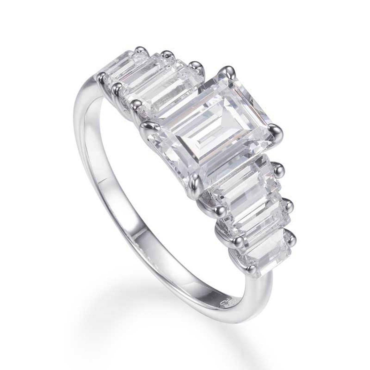 Exceptionally crafted, this impressive engagement ring showcases a large emerald cut centre cubic zirconia measuring 2.53ct, flanked on either side by three beautifully matched tapered baguette cut cubic zirconia, prong-set in a stunning high gloss