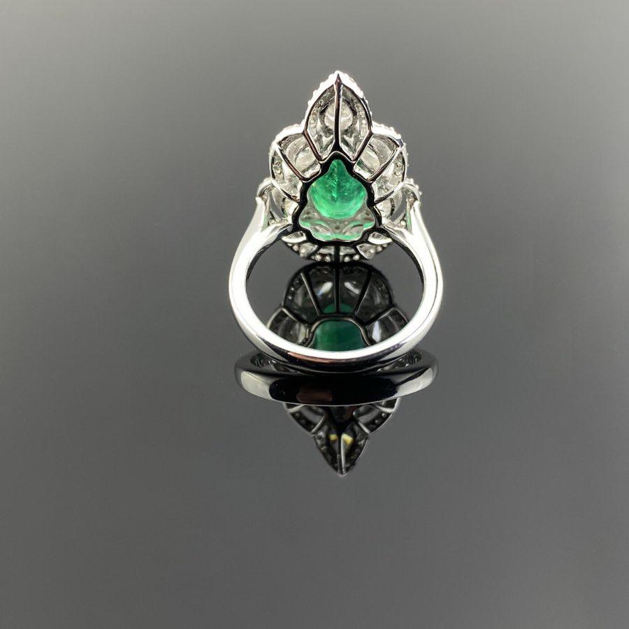 A beautiful art-deco inspired 2.53 carat pear shape Zambian Emerald cocktail ring, surrounded with 2.04 carat marquise shaped White Diamonds and 0.39 carat brilliant cut Diamonds. The center stone is of an exceptional quality, transparent and vivid