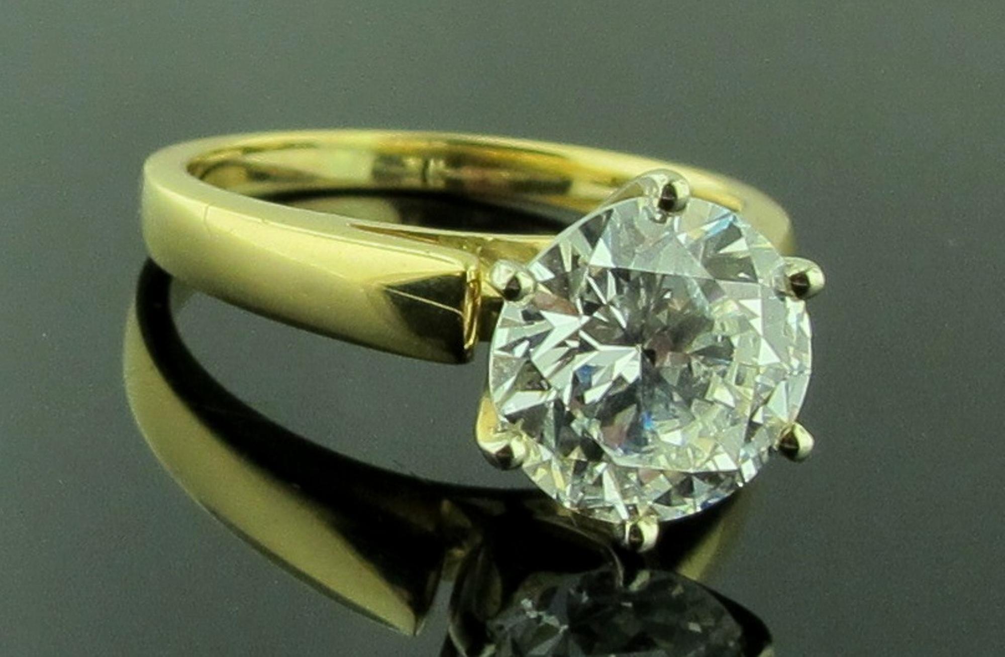 Set in 14 karat yellow gold is a 2.53 carat Round Brilliant Cut diamond solitaire.  J Color, SI-2 Clarity.  Ring size is 6.