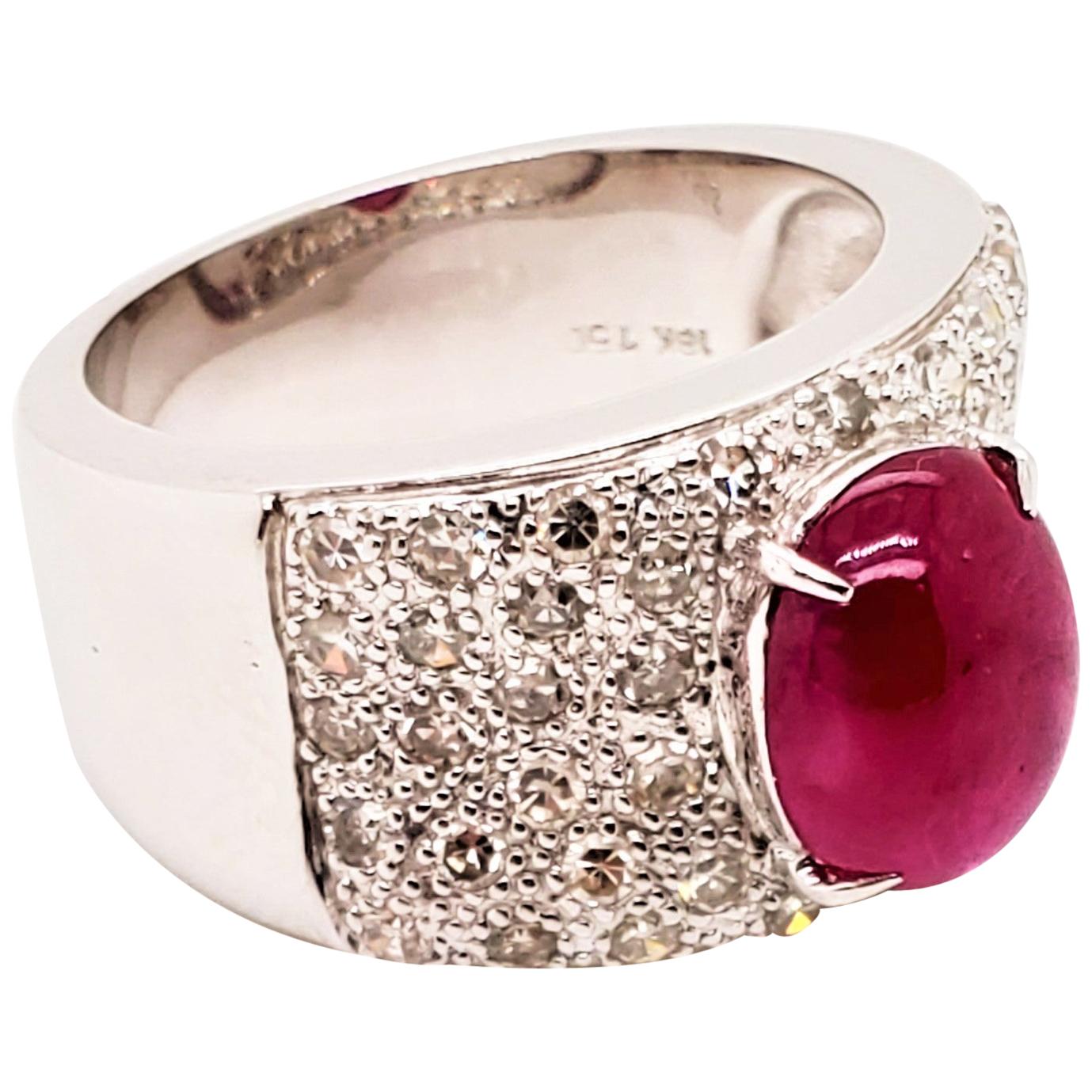 2.53 Carat Ruby Cabochon And Diamond White Gold Engagement Ring:

A beautiful ring comprised of a 2.53 carat vivid red ruby cabochon and surrounded by numerous white diamonds weighing 0.8 carat! The ruby is of vivid red colour, with good lustre and