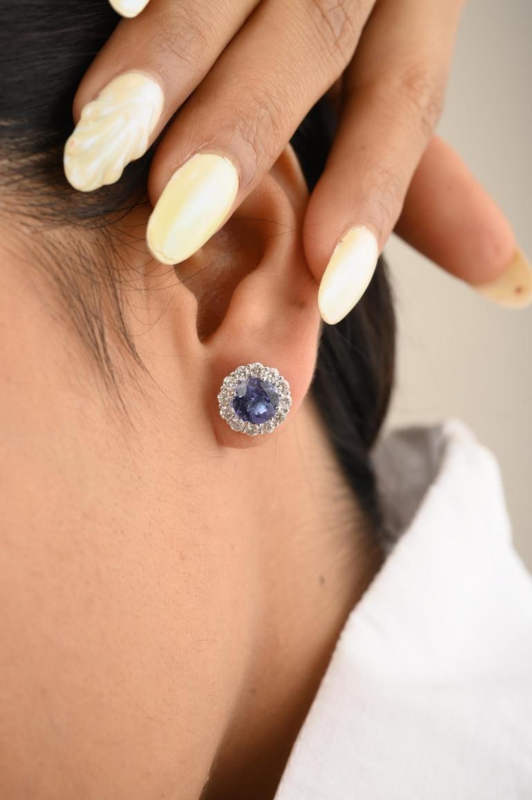 Tanzanite Halo Diamond Stud Earrings in 18K Gold to make a statement with your look. You shall need stud earrings to make a statement with your look. These earrings create a sparkling, luxurious look featuring round cut tanzanite.
Tanzanite brings