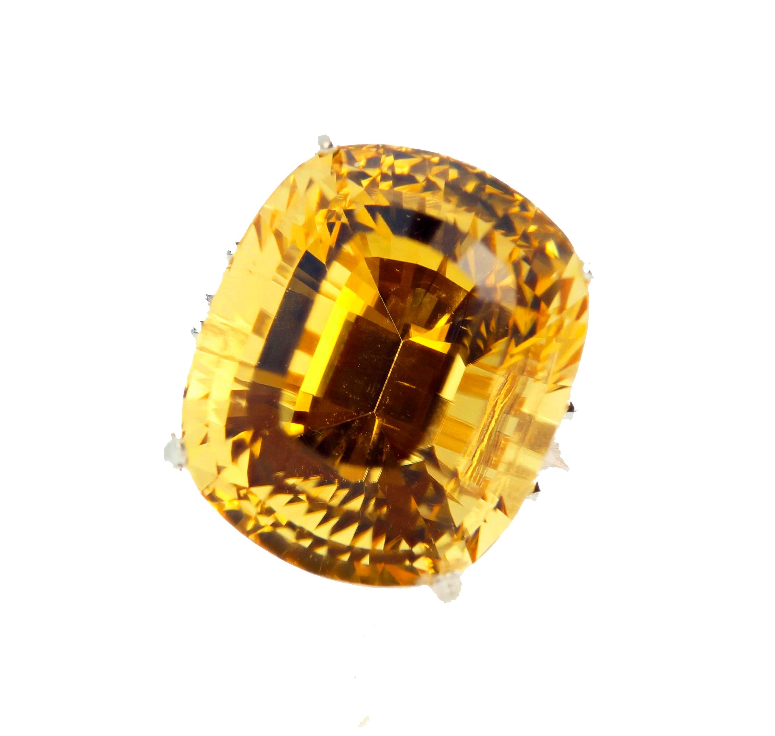 Glittering brilliant yellow Cushion cut 25.33 Carat Scapolite from Madagascar is set in a Sterling Silver ring size 6 (sizable FOR FREE).  This gorgeous Scapolite measures 18.5 mm x 15.5 mm and is absolutely eye clean.  It glitters all day and all