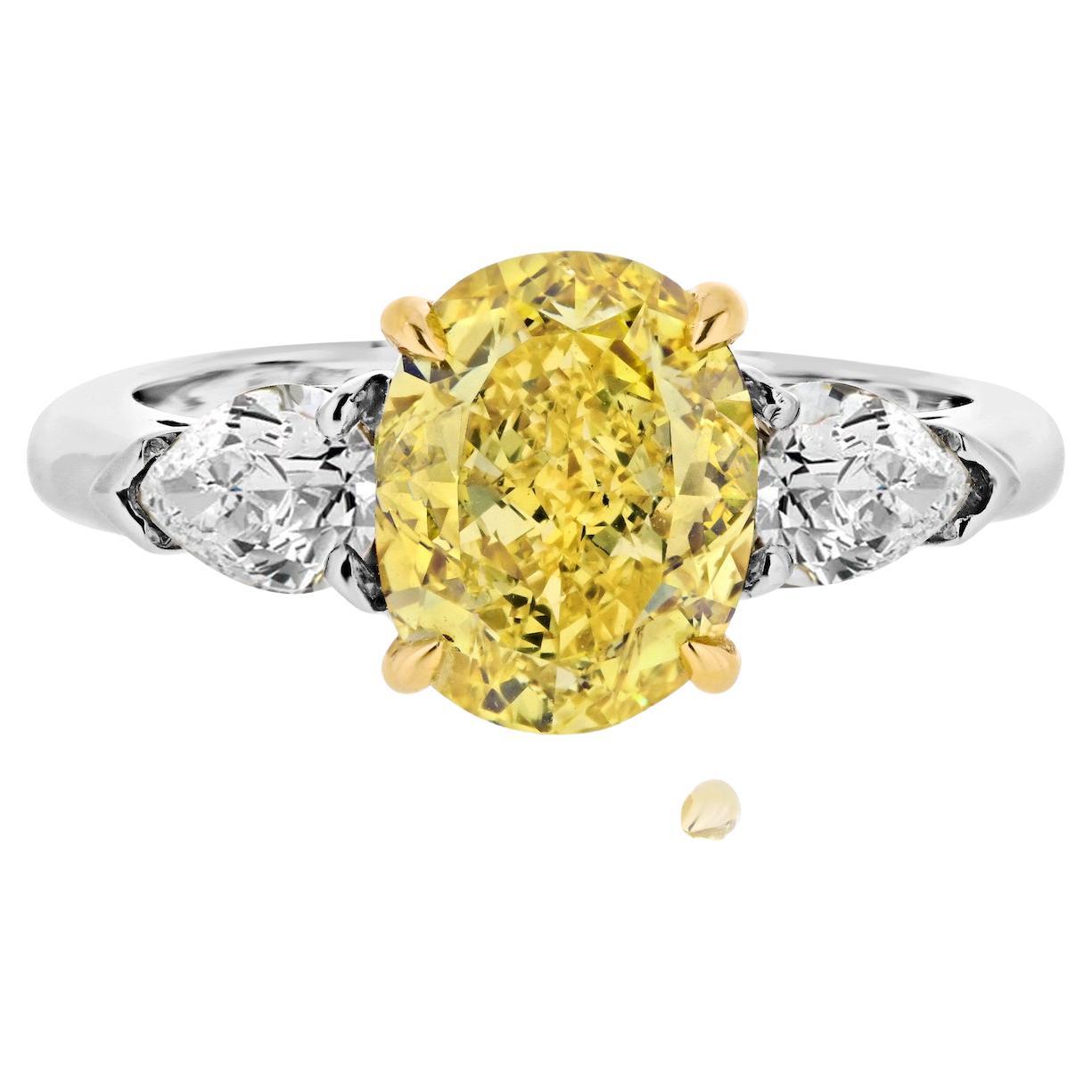 2.53ct Fancy Vivid Yellow Oval Cut And Pear Cuts Three Stone Ring For Sale