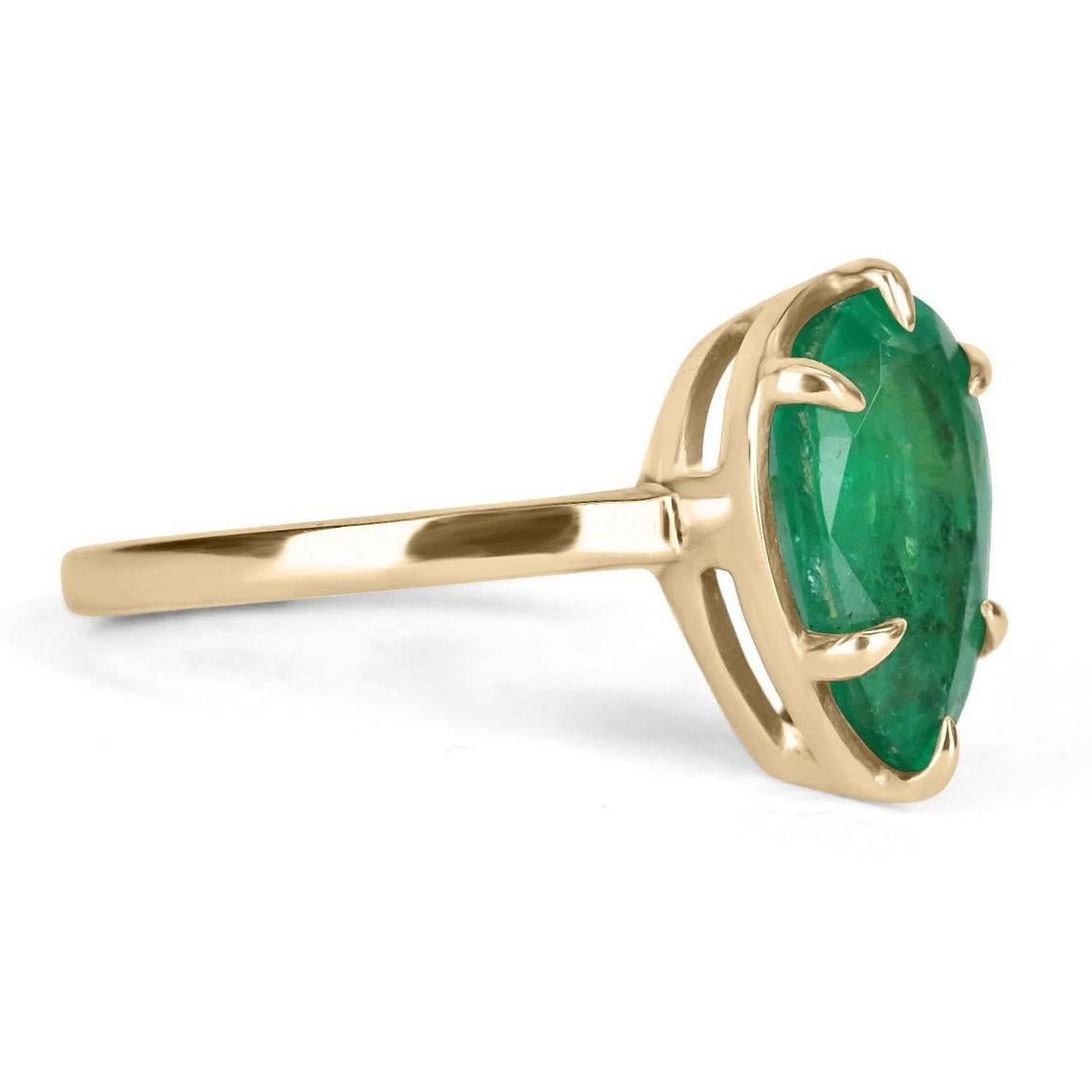 Displayed is a classic Colombian emerald solitaire pear-cut engagement ring/right-hand ring in 14K yellow gold. This gorgeous solitaire ring carries a full 2.53-carat slender emerald in a six-prong setting. Fully faceted, this gemstone showcases