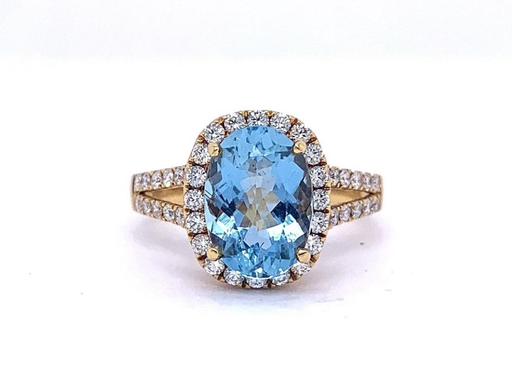 This stunning Aquamarine is a vibrant light blue and surrounded by brilliant cut white diamonds. 
Aquamarine= 2.54 carats 
44 diamonds = .59 carats total weight. 
Set in 18 karat yellow gold 