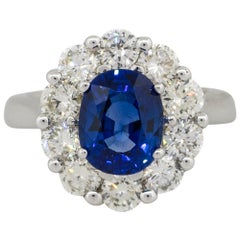 2.54 Carat Oval Sapphire Ring with Diamond Halo 18 Karat in Stock