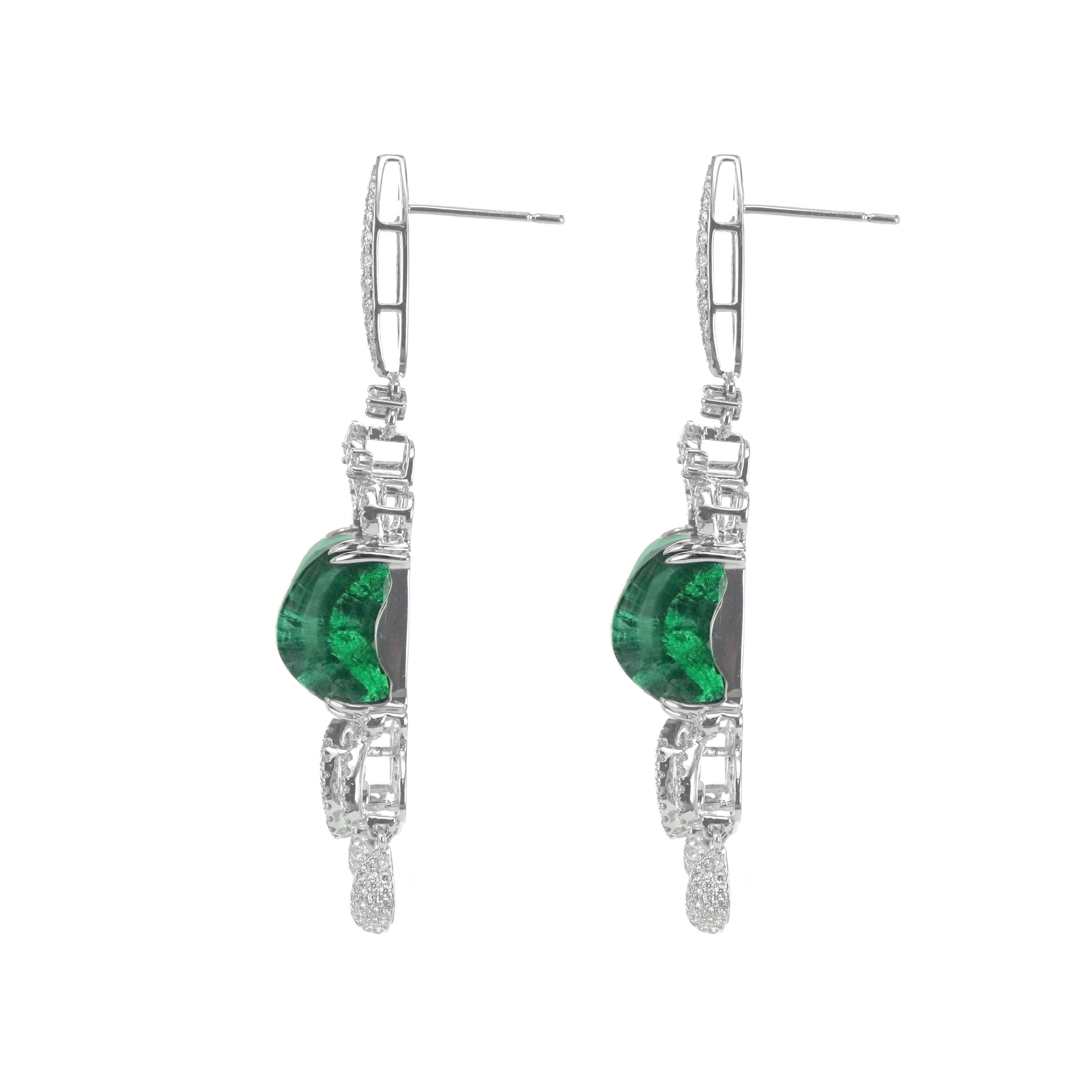 A massive pair of 25.45 carat of vivid green emerald are set along with 1.78 carat of white brilliant round diamond. The gorgeous dangle earring is a must wear for all red carpet events. 
The details of the earring are mentioned below:
Color: