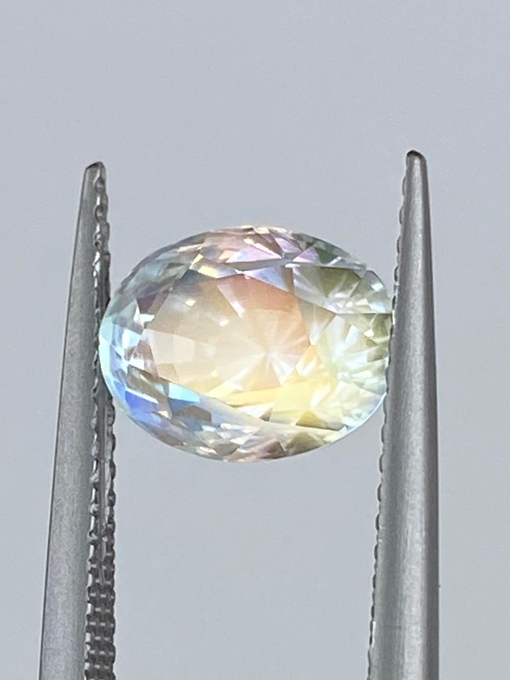 The Sapphire Merchant presents this exceptional Malagasy Rainbow Moonstone (Labradorite), a mesmerising natural gemstone that exhibits a unique and visually stunning play on colour. With a generous weight of 2.54 carats and an elegant oval shape