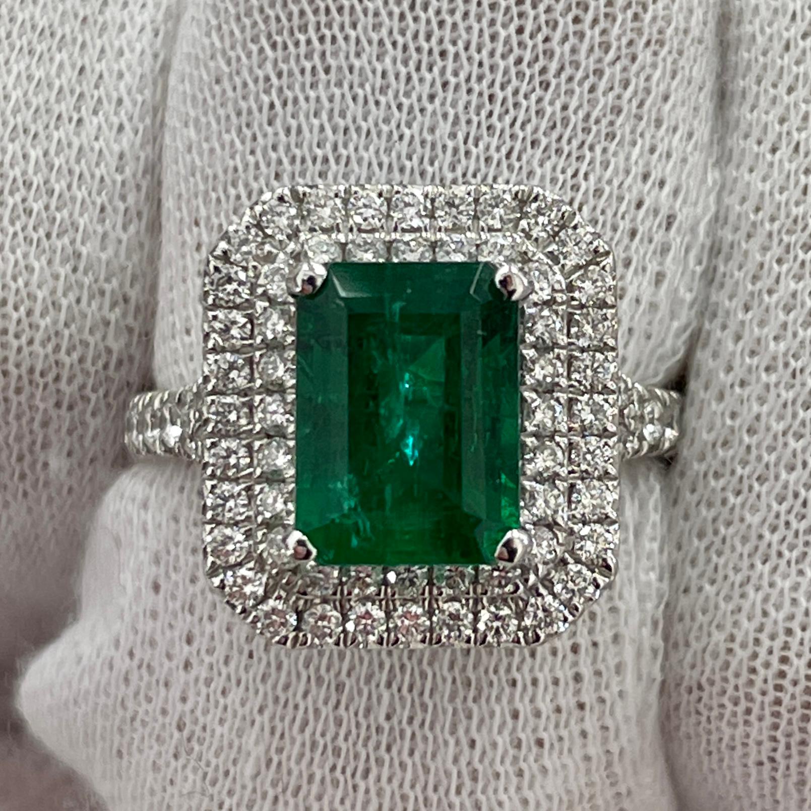 This is a very open color emerald cut emerald, mounted in an elegant 18K white gold and diamond ring with 0.80Ct of brilliant white diamonds. Suitable for any occasion!