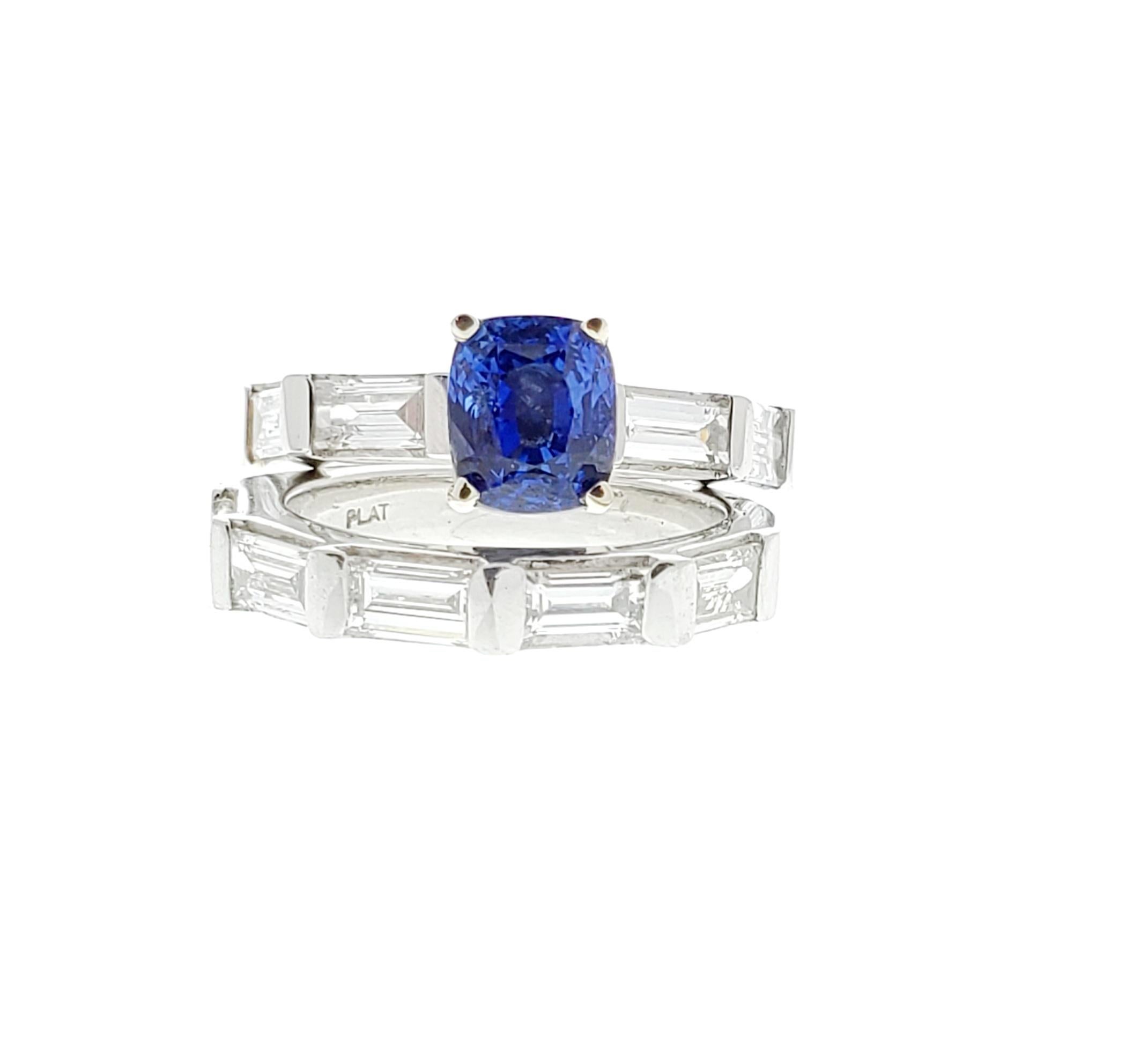 Designed in brightly polished platinum, this beautiful diamond and sapphire ring features a center-set cushion cut sapphire with a weight of 2.55 carat and exhibits an intense blue color with overall good saturation. This sapphire is complemented by