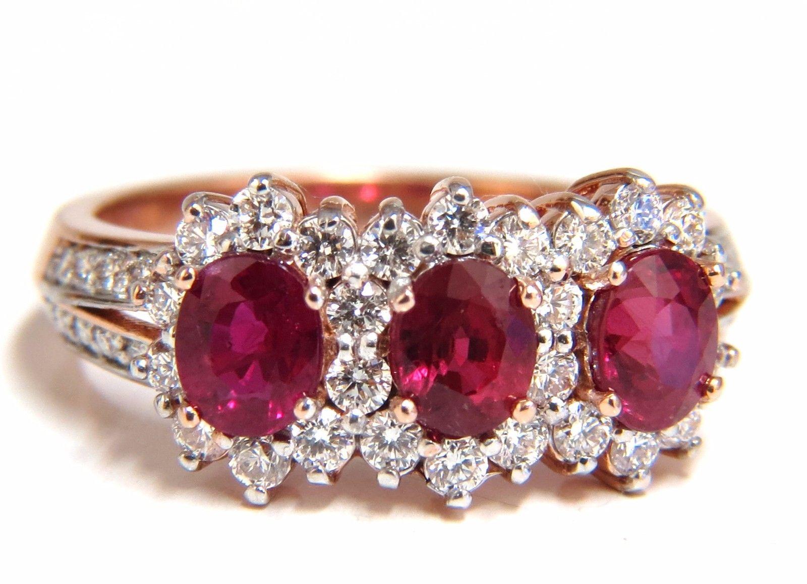 Ruby Halo Three's

1.84ct natural Rubies ring.

Vibrant vivid Reds

Transparent & clean clarity.

Oval cut brilliants

Average Each Ruby: 4.2 x 5.4mm 

.71ct natural Side diamonds:

G-color Vs-2 clarity.

14kt. rose gold

4.1 grams

Deck of ring: