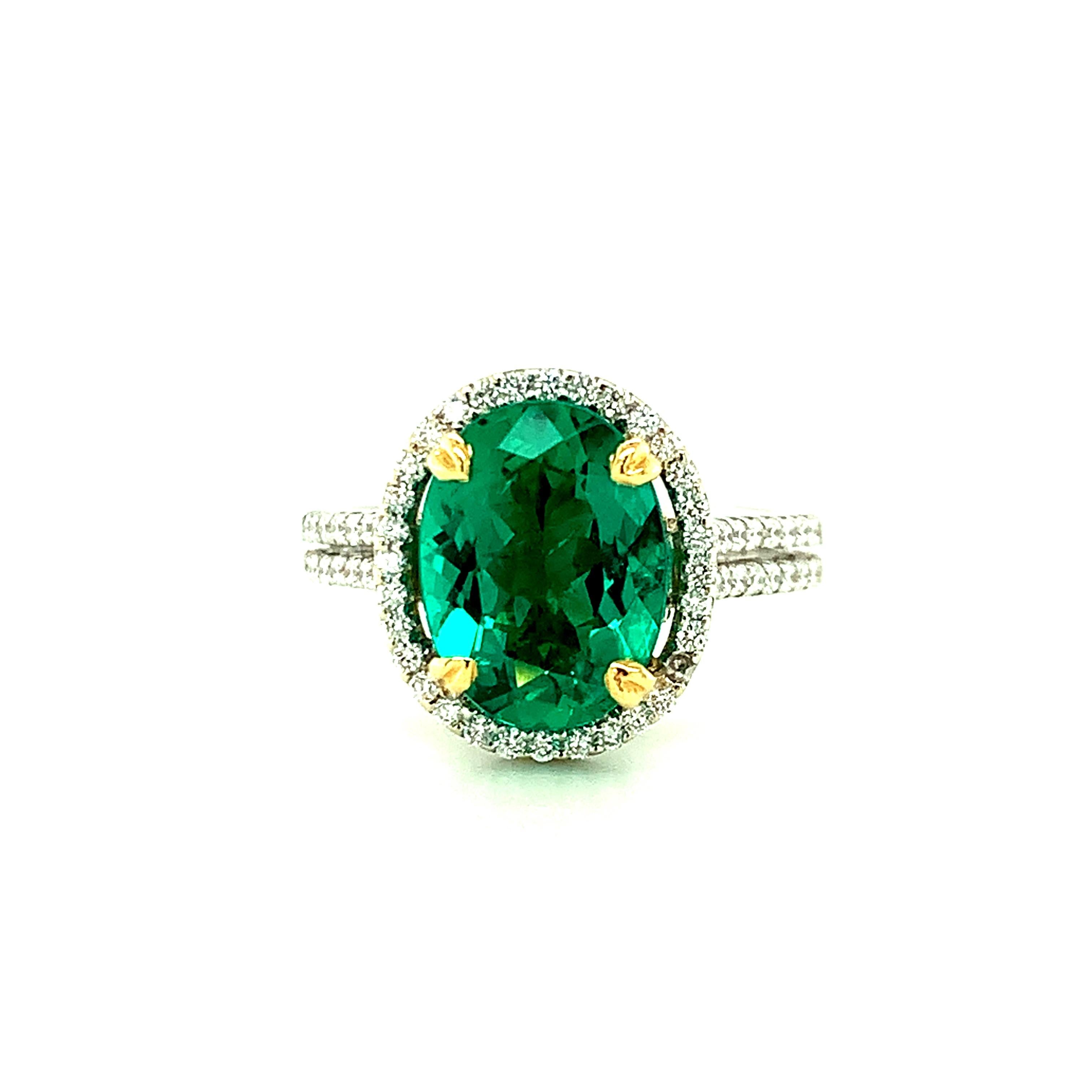 This exquisite cocktail ring features a 2.52 carat, extremely fine Brazilian emerald oval with superior clarity! With exceptionally rich, vibrant green color and a hint of elegant blue, this is a real gem! The emerald has been faceted as an oval,