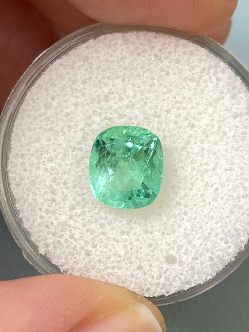 Stone: Emerald
Weight: 2.55-carats
Shape: Cushion Cut
Clarity: Transparent
Luster: Very Good
Color: Light Green
Measurements: 8.46mm x 7.58mm x 5.89mm
Geographic Origin: Colombia
Treatment: Natural, Oiling

Comments: Due to their growth conditions
