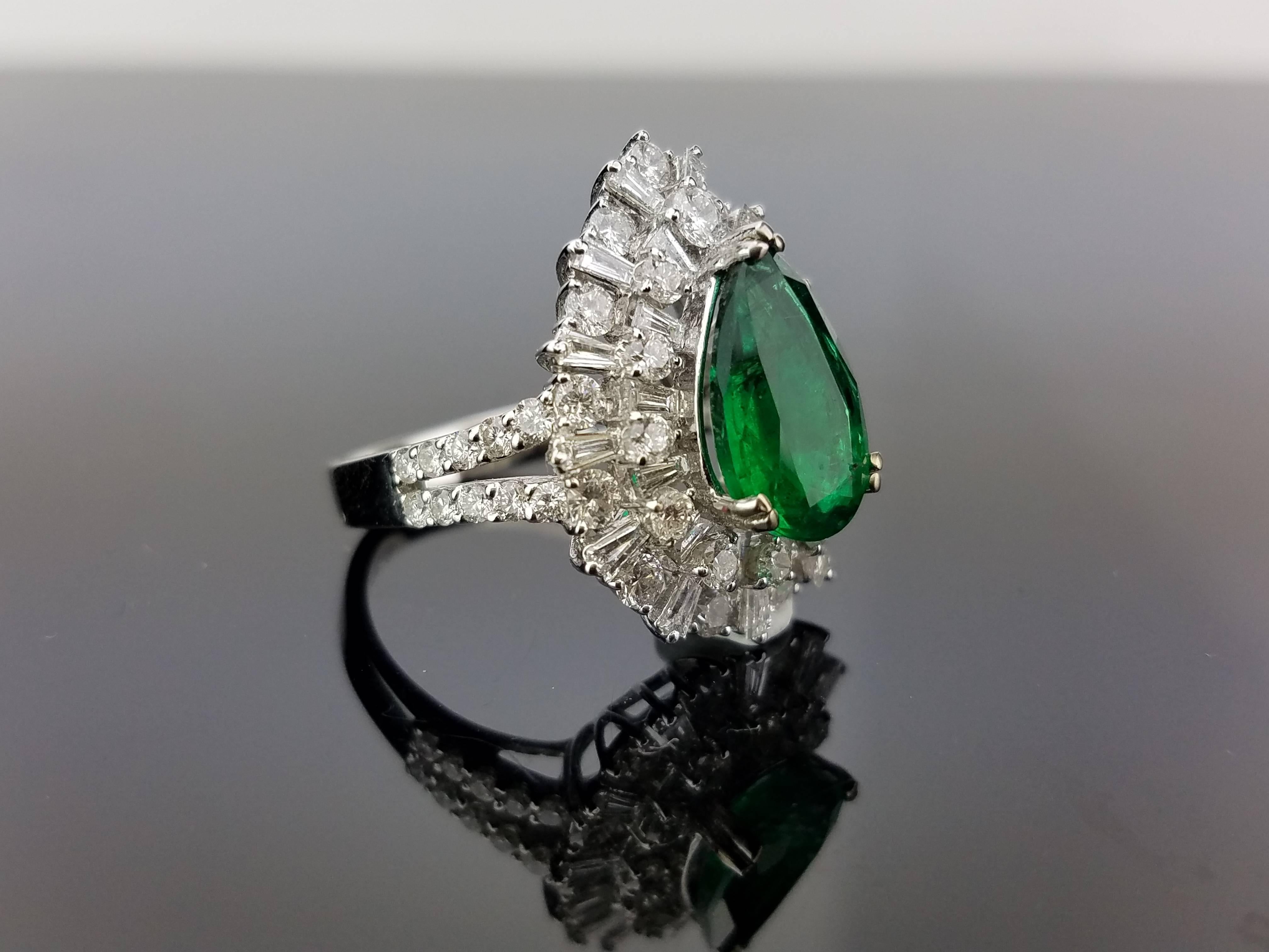 A statement 2.55 carat pear shape Zambian Emerald and White Diamond cocktail ring, set in 18K white gold. 

Stone Details: 
Stone: Emerald
Carat Weight: 2.55 Carats

Diamond Details: 
Total Carat Weight: 2.08 carat
Quality: VS/SI , H/I

18K Gold: