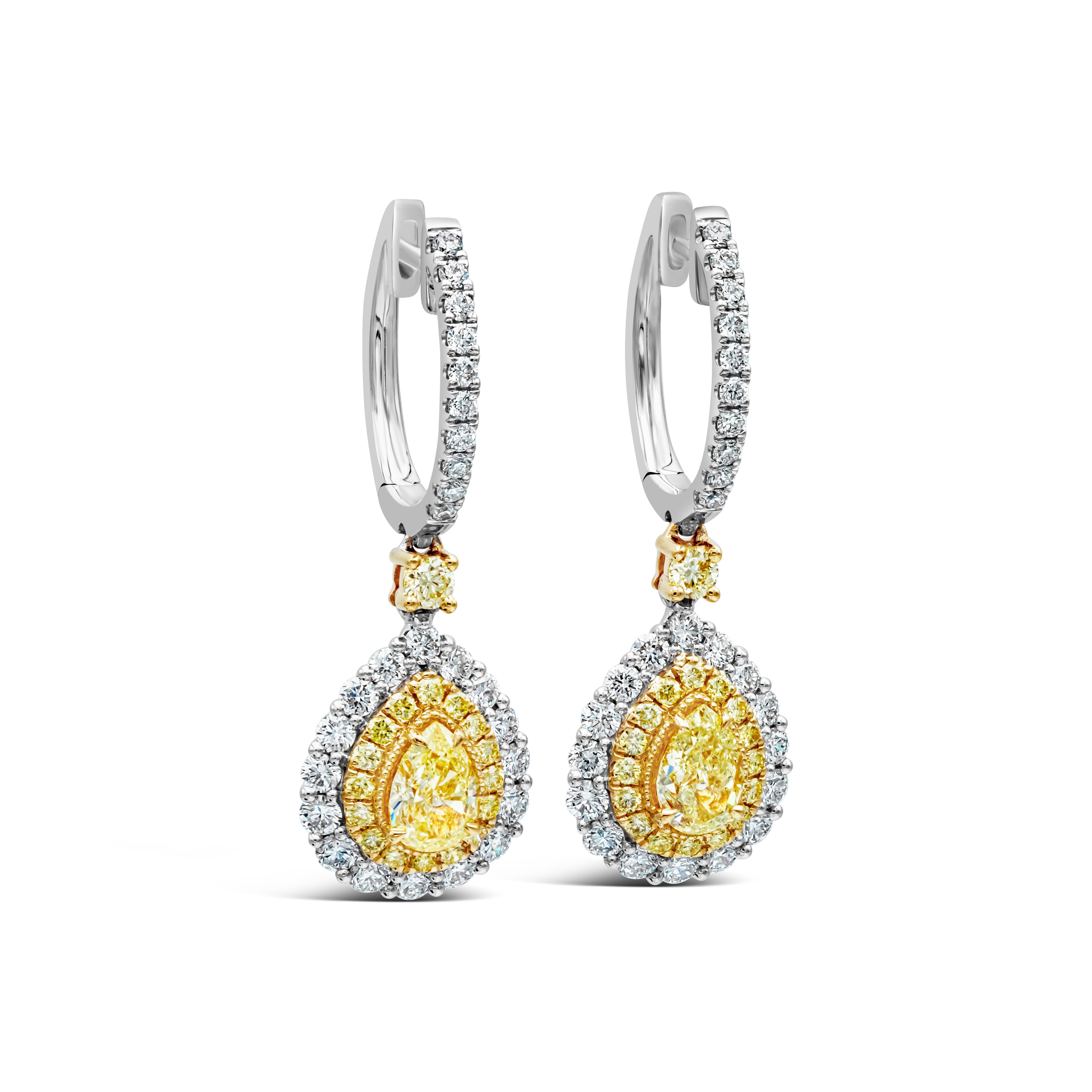 This pair of earrings showcases a pear shape yellow diamond surrounded by a double halo. The inner halo is made up of yellow round diamonds. The outer halo is made up of brilliant round diamonds. The two pear shape fancy yellow diamonds weigh 1.08