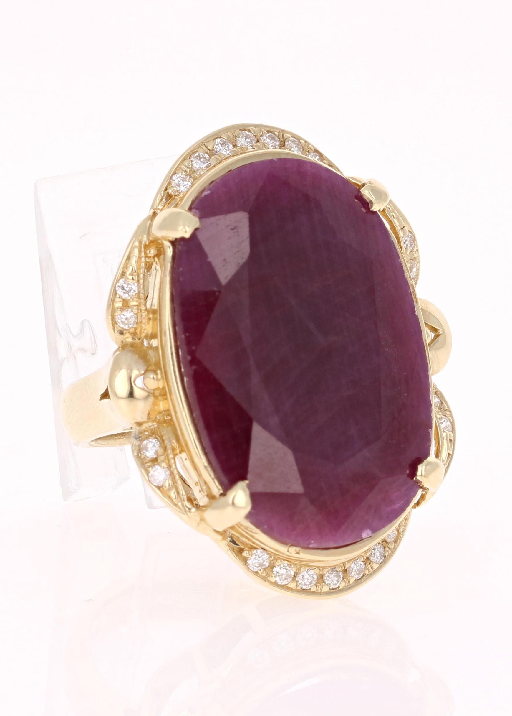 This ring is truly a one of a kind beauty!  
There is a large Oval Cut Ruby set in the center of the ring that weighs 25.31 carats.  
It is surrounded by 23 Round Cut Diamonds that weigh 0.28 carats.  
The total carat weight of the ring is 25.59