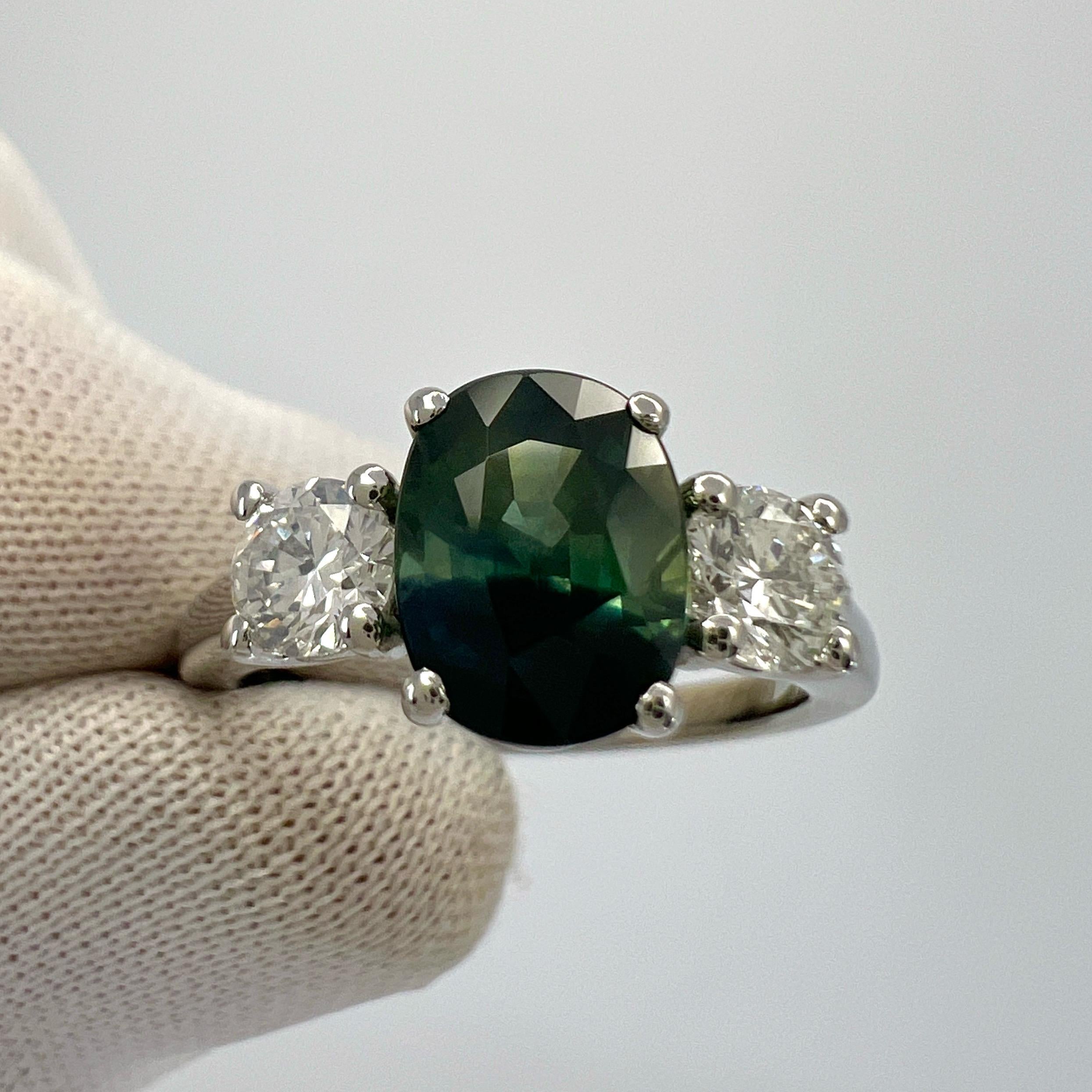 Unique Deep Blue Green Bi Colour Sapphire And Diamond Three Stone 950 Platinum Ring. 2.55 Total Carat.

2.05 Carat centre sapphire with a deep blue green bi colour effect.  Fascinating and unique colour variation. Similarly seen in watermelon
