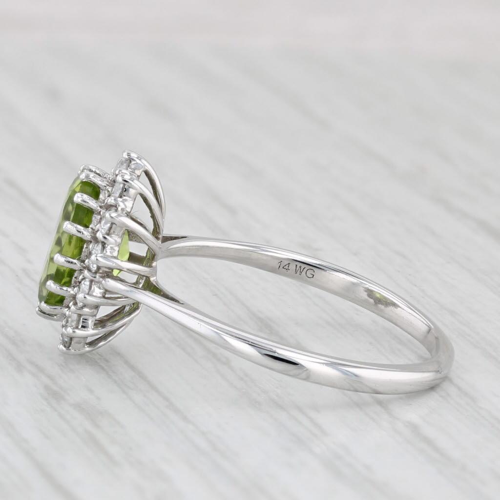 Gemstone Information:
- Natural Peridot -
Carats - 2.15ct
Cut - Oval Brilliant
Color - Light Green

- Natural Diamonds -
Total Carats - 0.40ctw
Cut - Round Brilliant
Color - F - G
Clarity - SI1- SI2

Metal: 14k White Gold
Weight: 3.1 Grams 
Stamps:
