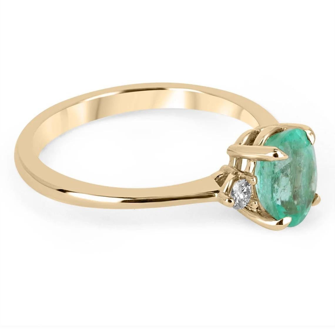 A classic Colombian emerald and diamond three-stone ring. Dexterously crafted in gleaming 14K gold this ring features a 2.20-carat natural Colombian emerald-oval cut from the famous Chivor mines. Set in a secure prong setting, this extraordinary