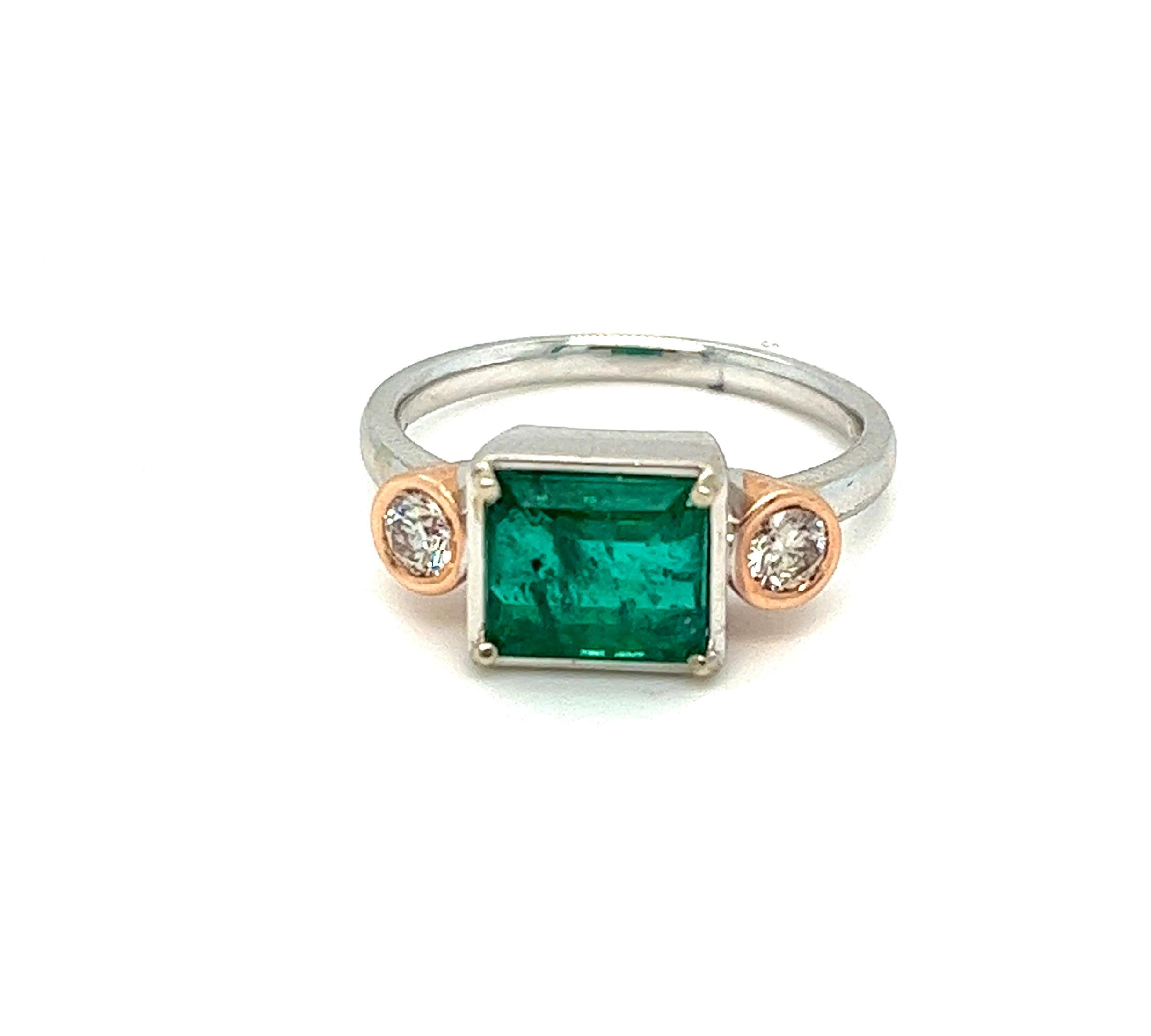 Offered here is natural earth mined Emerald from Colombia, weighing 2.56 carats, stunning deep green in color with natural inclusions.
Emerald is set within a 4 prong basket flanked with 2 natural earth mined diamonds weighing 0.30 carat together,