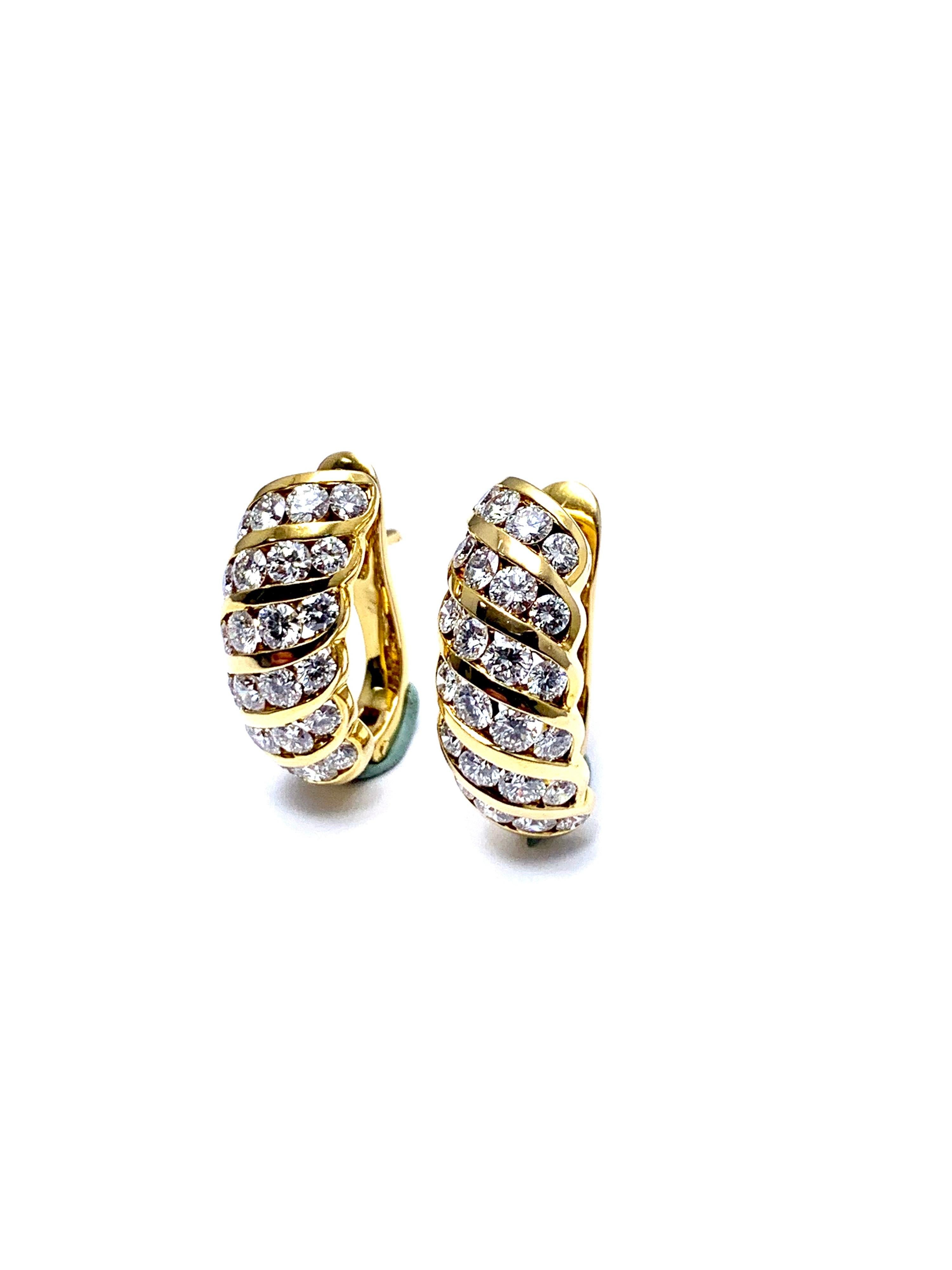 An extremely vibrant pair of round brilliant Diamond earrings.  The earrings contain 48 Diamonds with a total weight of 2.56 carats, graded as G color, VS clarity, and cut to deliver the maximum fire that a diamond should.  The Diamonds are all