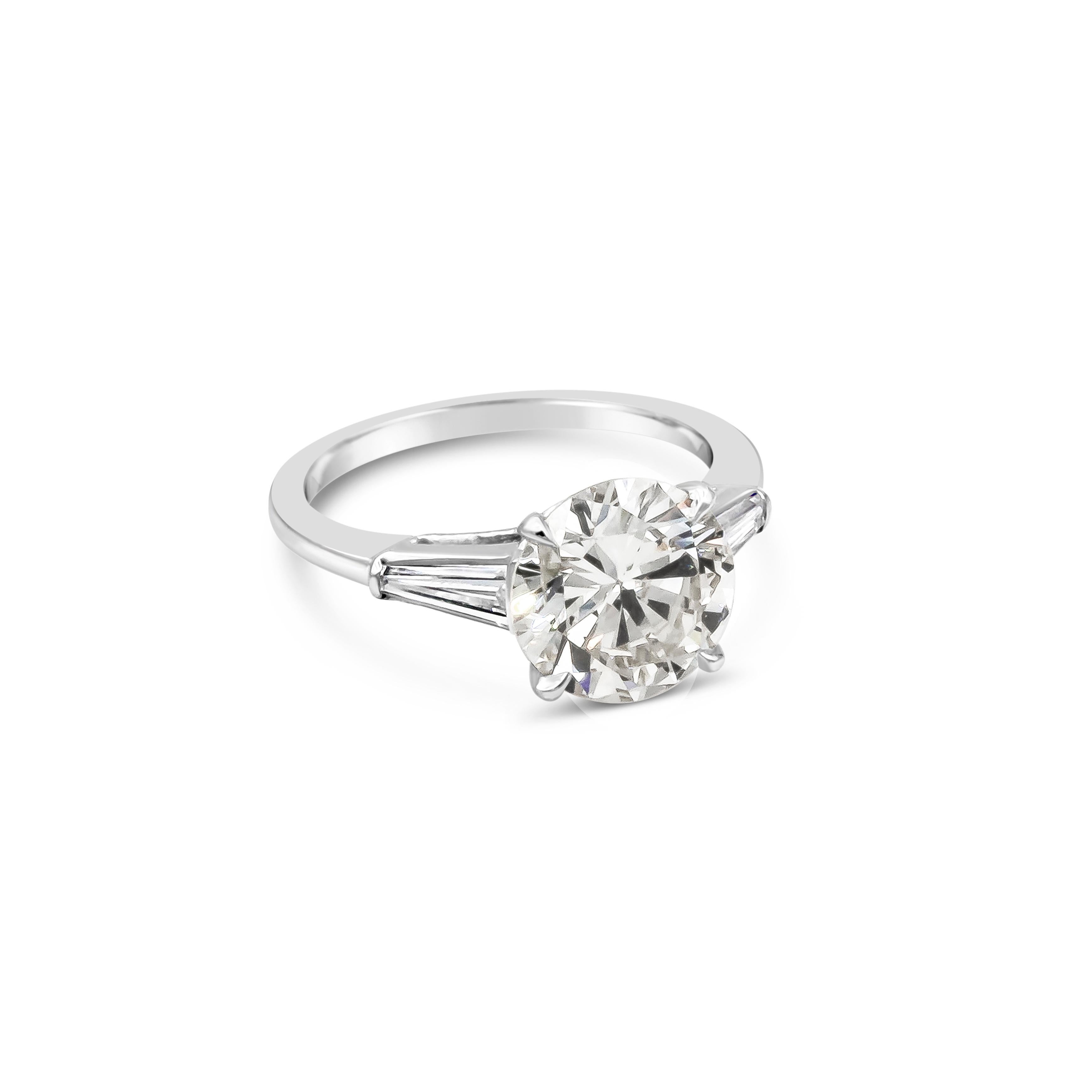A timeless classic. Tapered baguette diamonds weighing approximately 0.20 carats each, elegantly compliment the gorgeous 2.56 carat diamond center. Set in a polished platinum composition. One of the most popular among the different styles of three