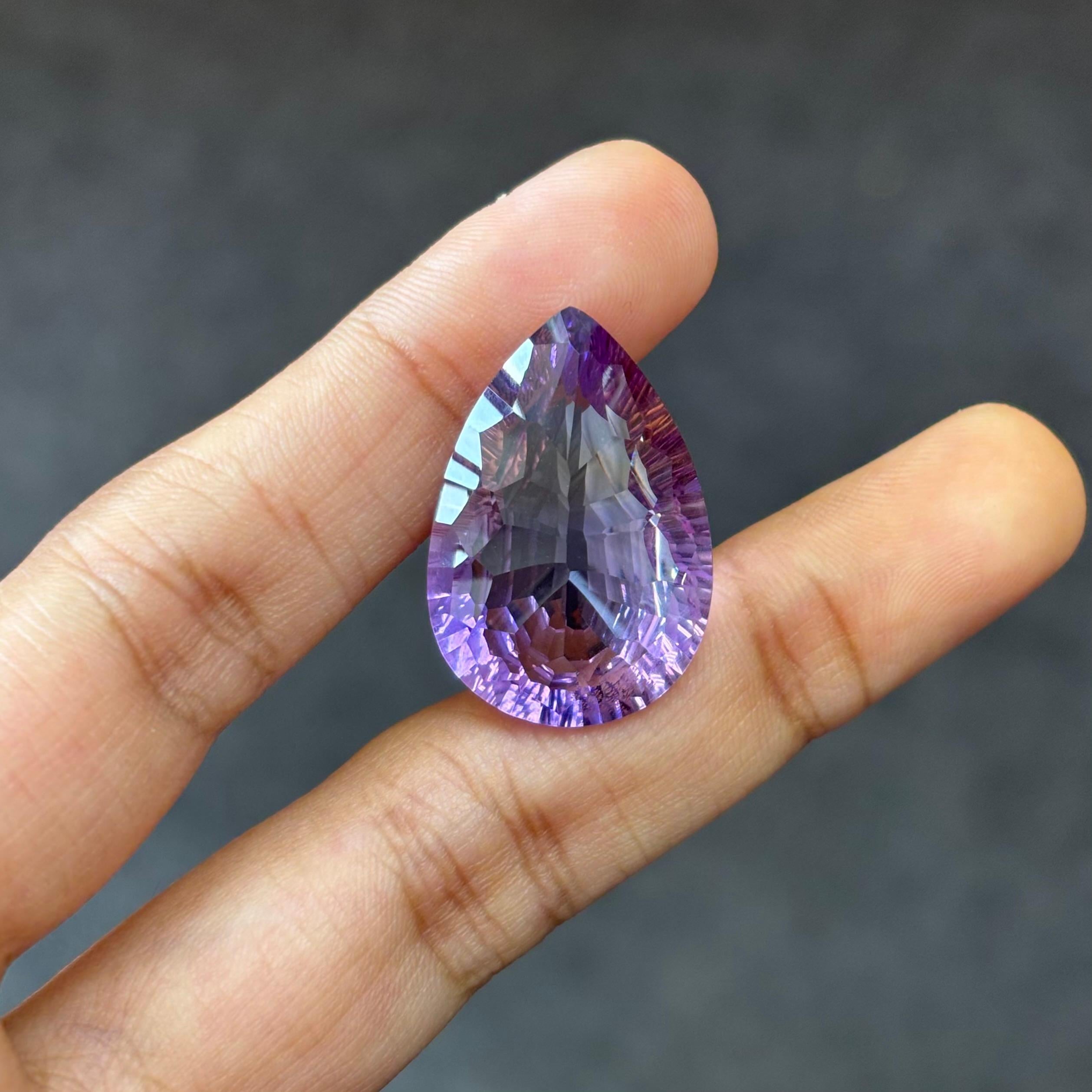 A 25.63 Carat Ametrine gemstone, resplendent in hues of vivid purple. The Ametrine is cut to perfection in a pear shape.

Ametrine is said to be the perfect balance of the properties of an amethyst stone and a citrine stone. As a stone of both