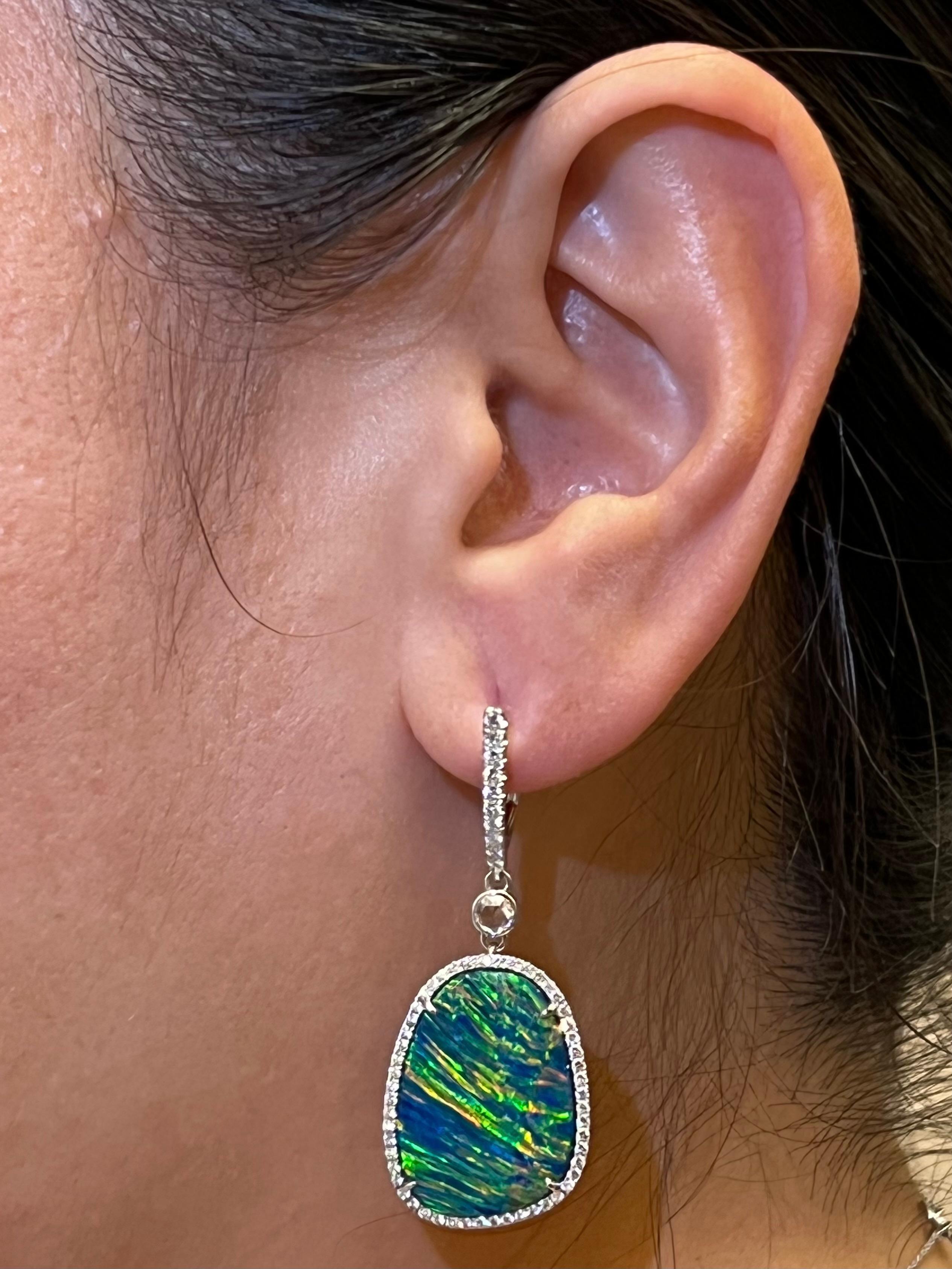 Please check out the HD video! These are Australian doublet Opals. Extremely difficult to find a matching pair this quality! When it comes to opals, one of the most important character people look for is the play of color. The Australian opals in